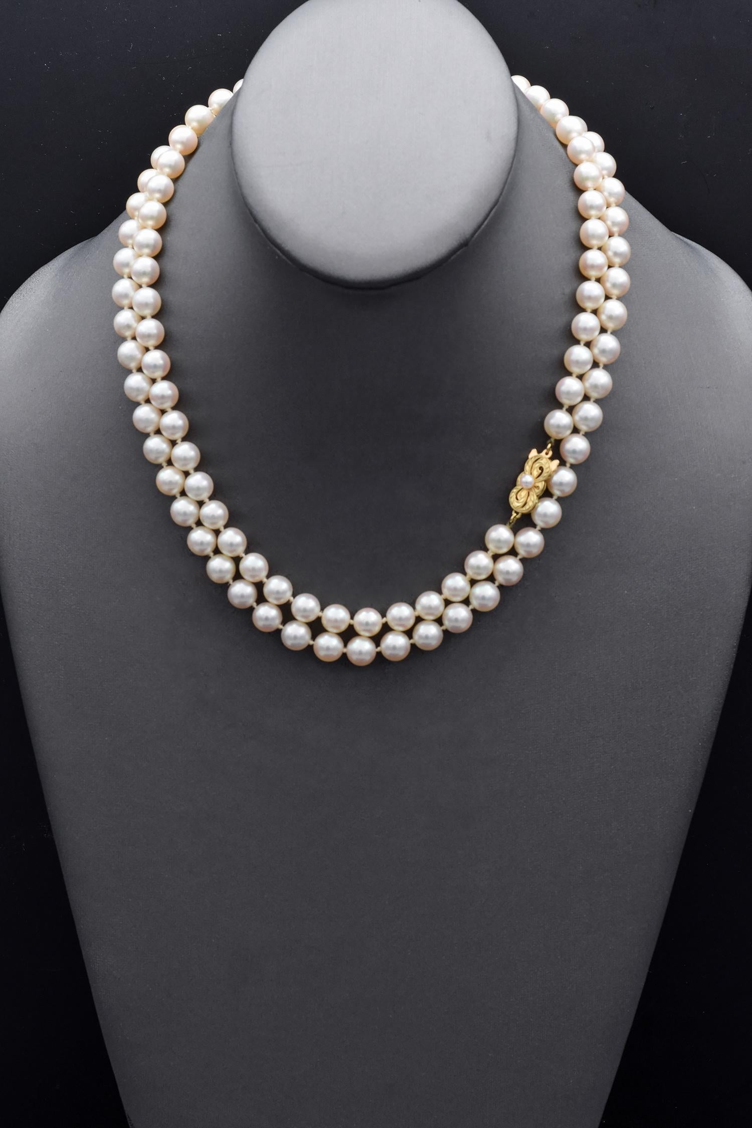 This exquisite beaded necklace is meticulously crafted by Mikimoto. The necklace features lustrous white pearls, each perfectly spherical and uniform in size. The clasp is made of 18k yellow gold, adding a touch of elegance and contrast to the
