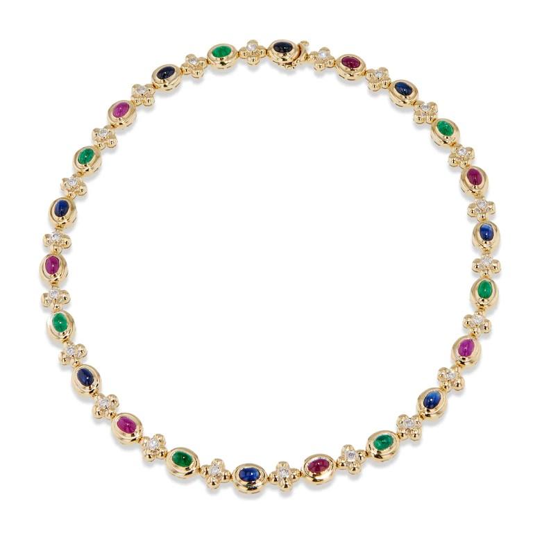 Admire the exquisite brilliance of the Multi-Color Yellow Gold Estate Necklace, featuring 8 Sapphires, 7 Rubies, 7 Emerald Cabochons, and 22 Diamonds totaling approximately 1.75 carat total weight. G/H in color and SI1/SI2 in clarity. 

Crafted from
