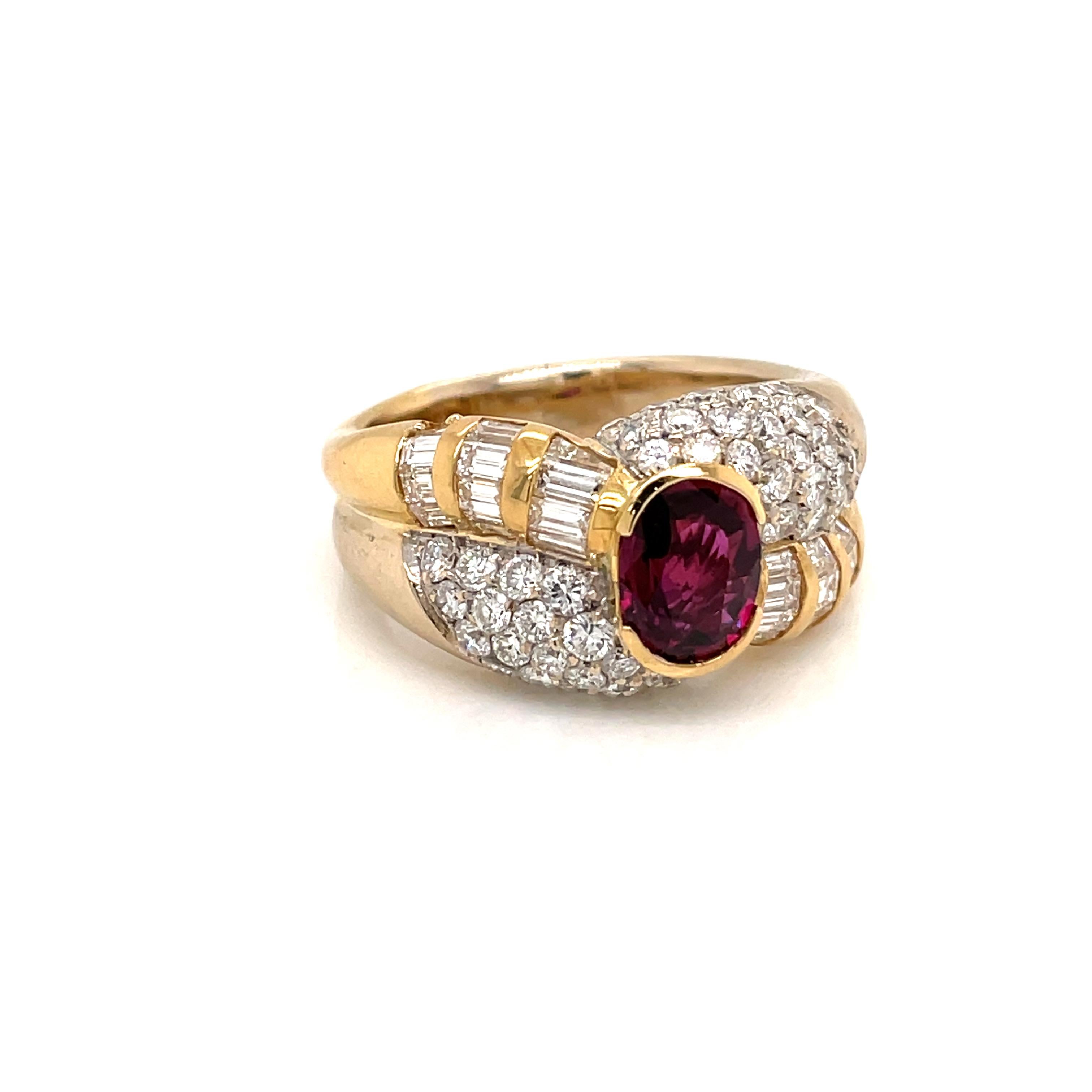 Beautiful and important 18K Yellow and White Gold Cocktail Ring centered with a Sparkling Oval cut Natural Unheated Ruby weighing 2 carat. It is set with fine Round brilliant and Baguette cut diamonds,  weighing total 4 carats, graded G color with