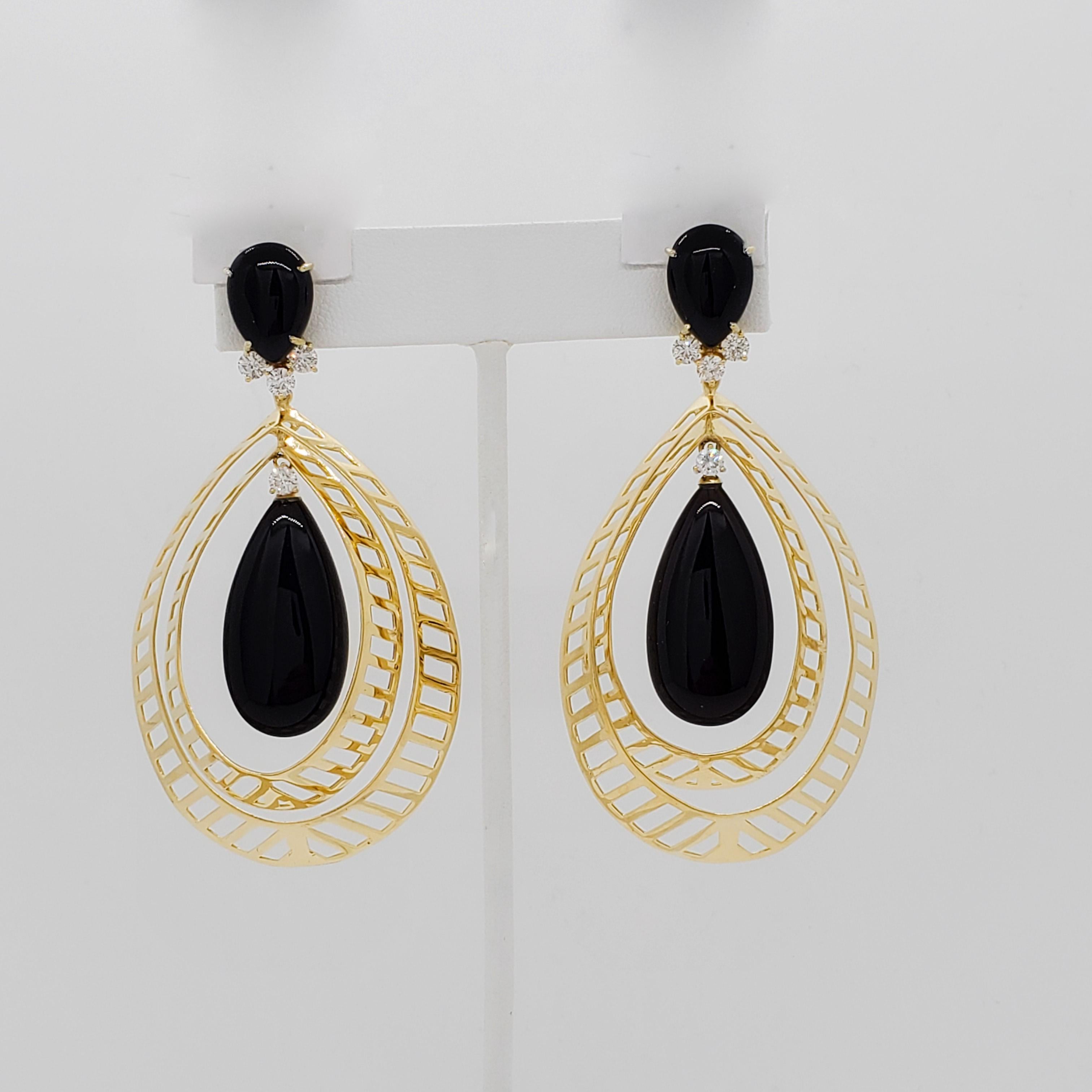 Beautiful earrings with large onyx cabochon pear shapes and 1.10 ct. of good quality, white, and bright diamond rounds.  Handmade in 18k yellow gold.