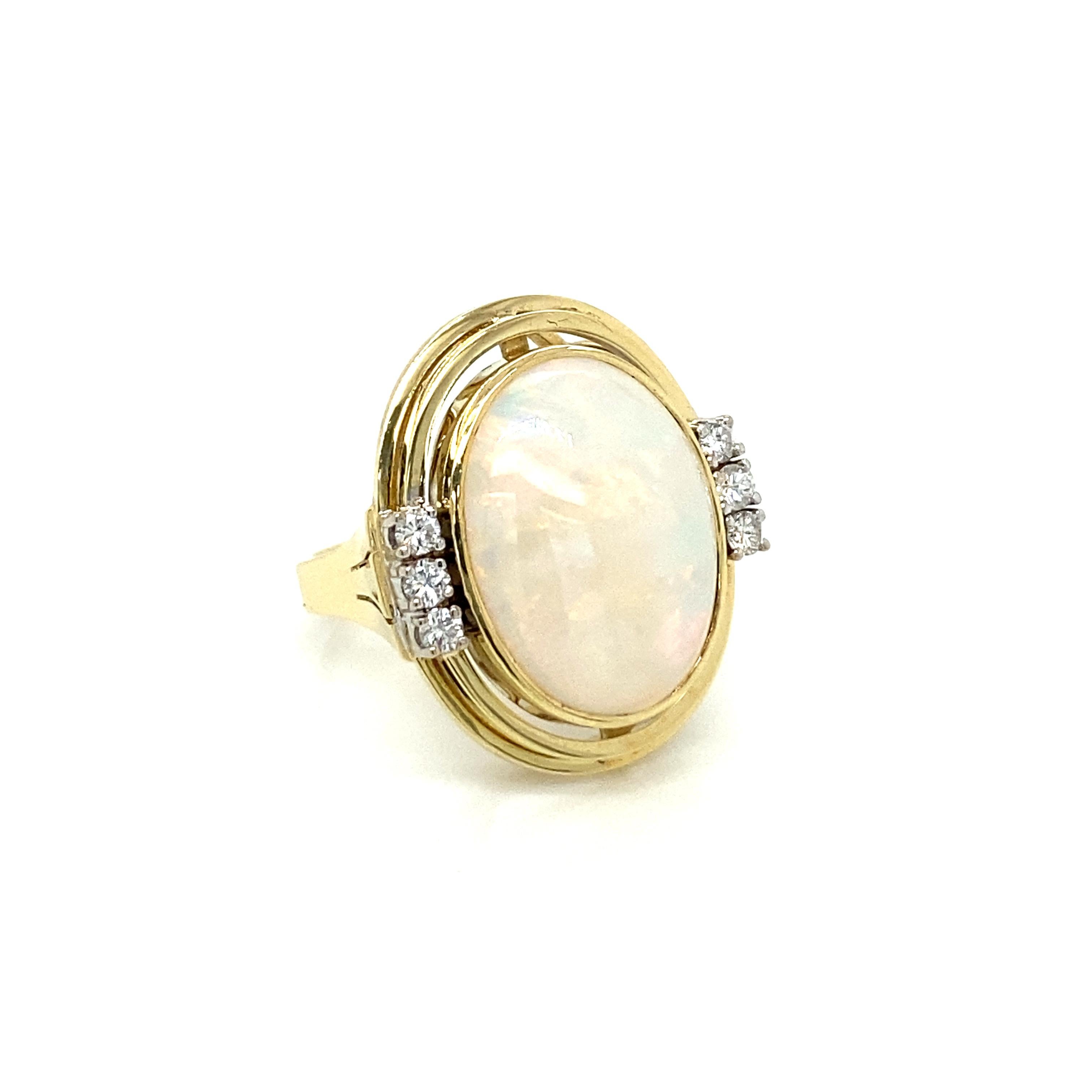 Beautiful and elegant ring, handmade in solid 14k yellow gold, dates 1970' Italy, It features in the center a large great quality Opal surrounded by three sparkling round brilliant cut diamonds on each side.
Excellent condition

CONDITION: Pre-Owned