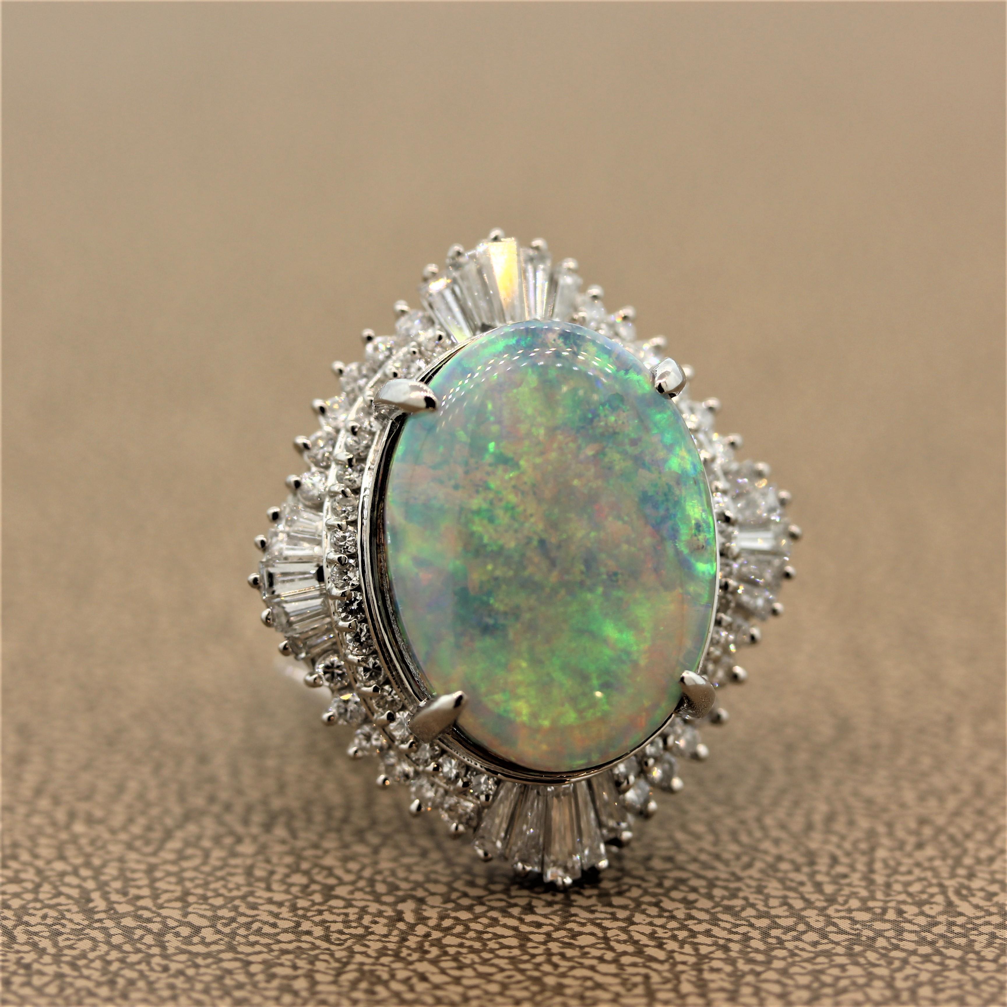 A vibrant estate cocktail ring featuring a 15.38 carat opal with exceptional play of color. The oval cabochon opal is haloed by 2.01 carats of colorless round cut diamonds with tapered baguette cut diamonds on its four sides. This platinum ring