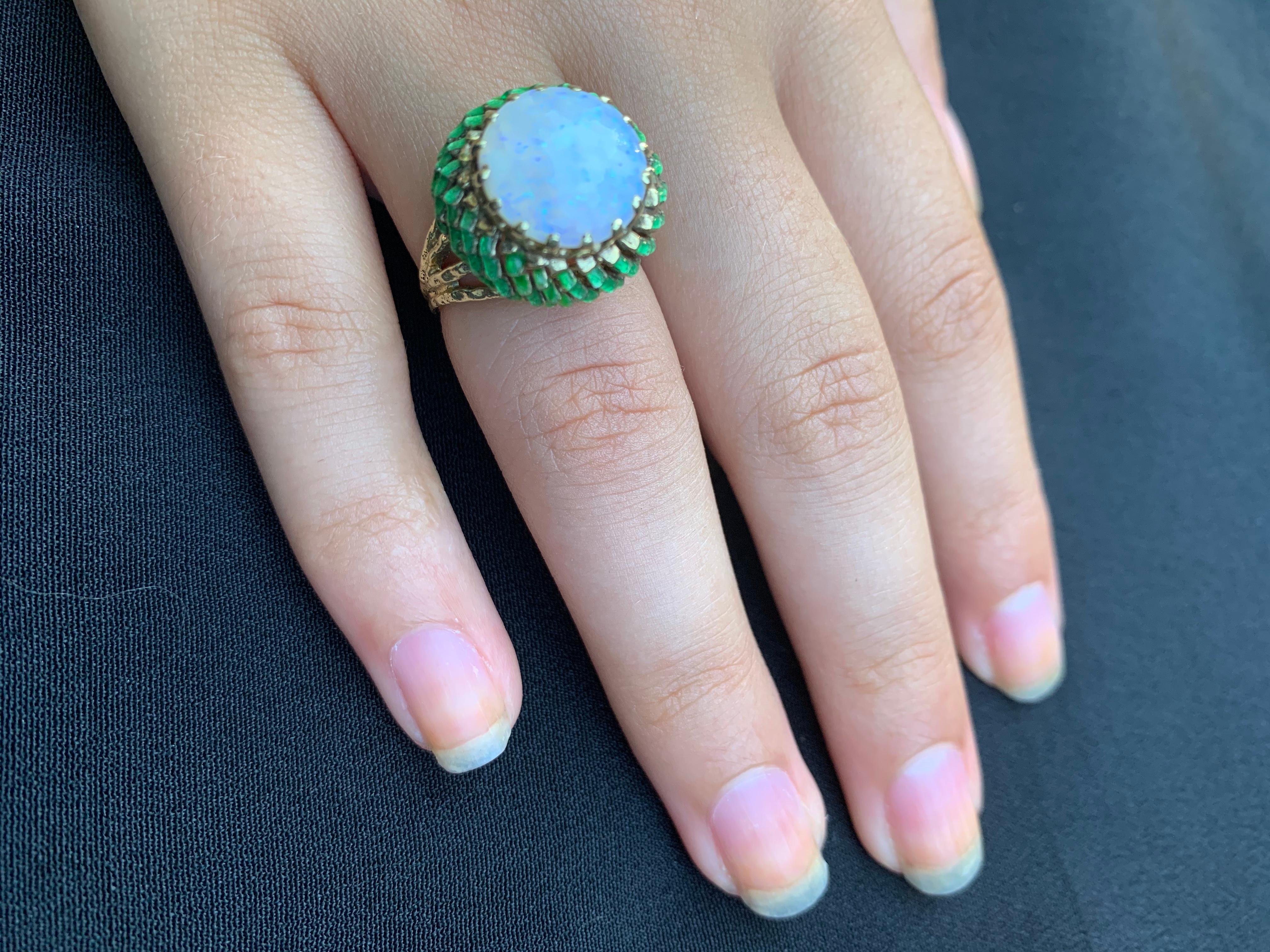 Very unusual vintage Thistle ring with a large round cabochon opal center (12mm in diameter) set in an intricate 14K yellow gold and green enamel setting representing the calyx portion of the flower, with naturalistic gold stems, eight in total,