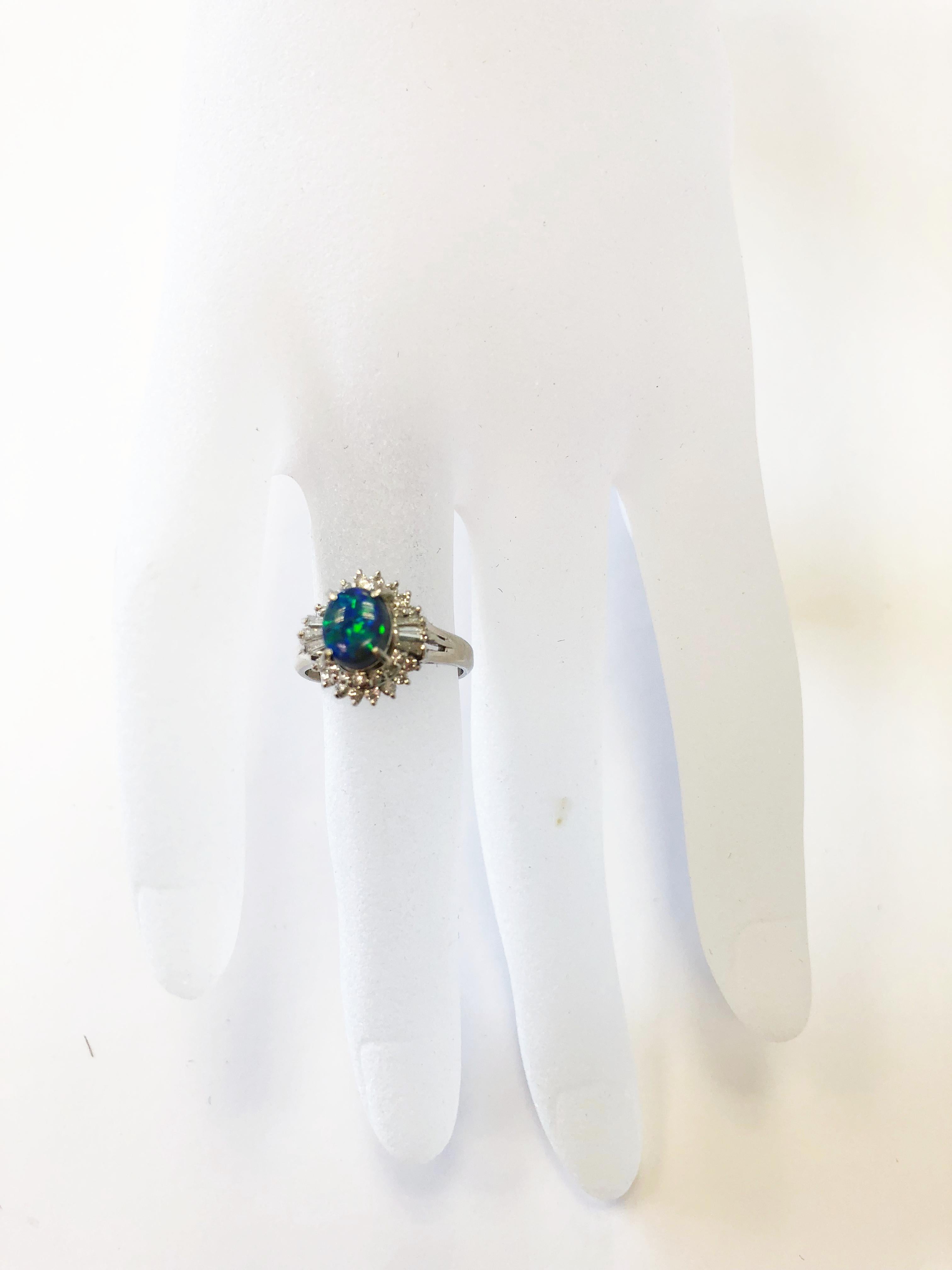 Stunning blue green opal oval weighing 0.93 carats with 0.53 carats of white good quality diamond rounds in a handmade platinum mounting.  Ring size 5.  Classic design with an eye catching stone.