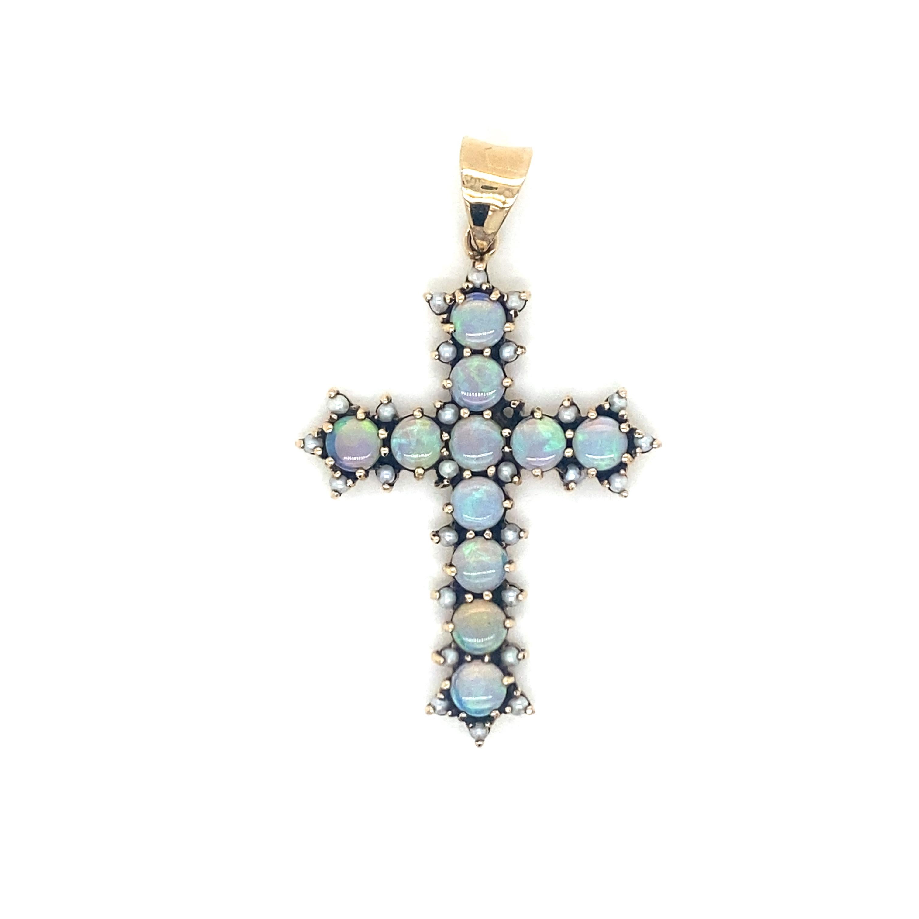 Unusual 14k yellow Gold Cross, it features sparkling Natural Opal and micro pearls.
Italy, circa 1980'

Measures: long 1,37 inches (3,5 cm) x wide 0,78 in (2,5 cm) 
Gross weight: 4 Grams   

The Jewel comes in a nice box with warranty 

*