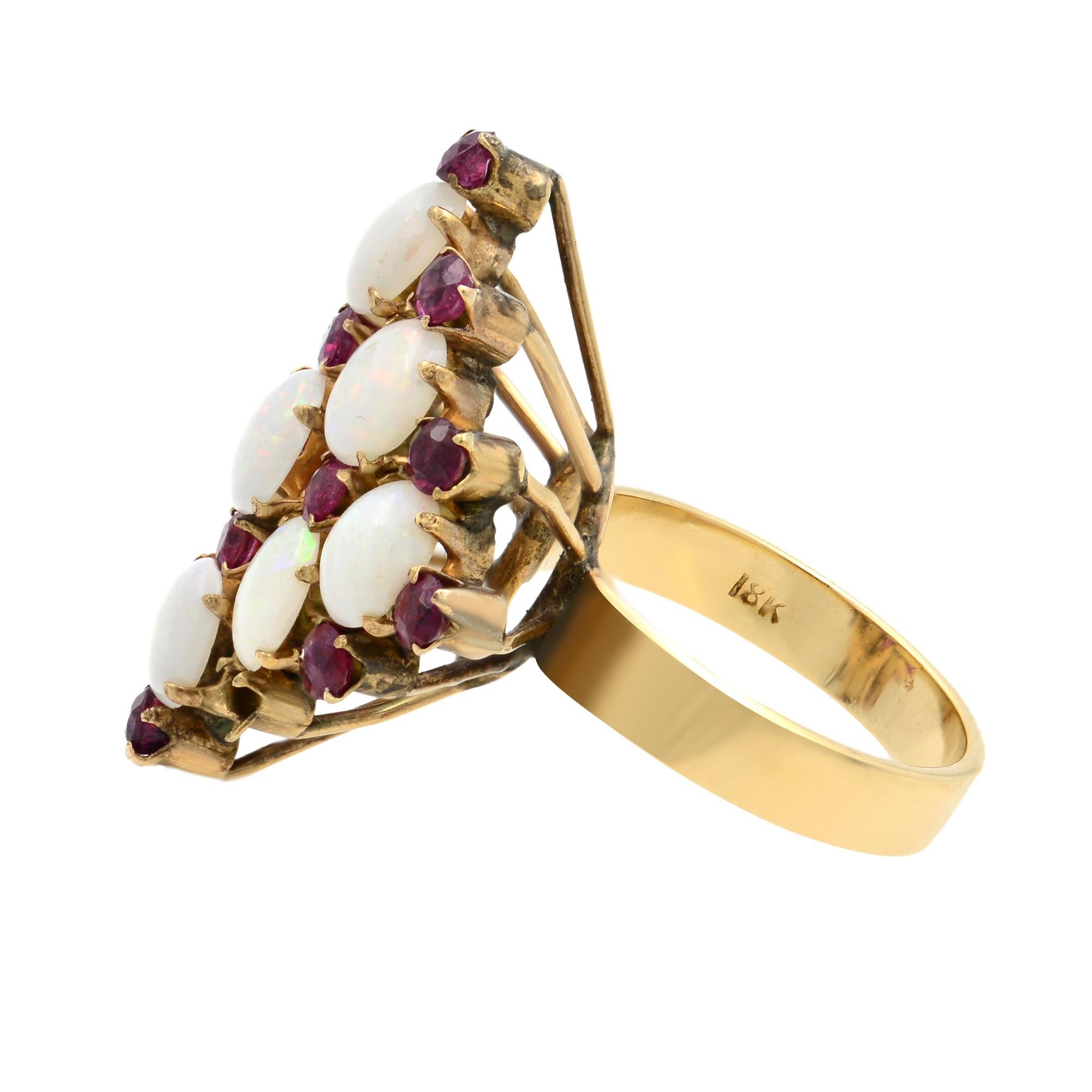 This Vintage Estate ring is crafted in 18k yellow gold. It features prong set oval shaped Opal and round cut Rubies. Ring size: 5.75. Total weight: 5.85 grams. Great pre-owned condition. Comes with a presentable gift box.
