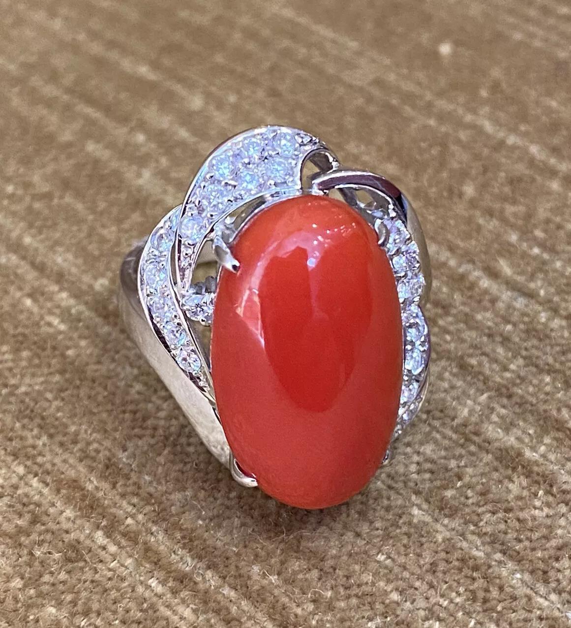 Estate Coral and Diamond Ring in Platinum

Estate Coral and Diamond Ring features a Large Oval Red Coral in the center accented by 23 Round Brilliant cut Diamonds in Platinum.

Diamond total weight is 0.51 carats.

Ring size is 7.25
Ring weighs 14.2