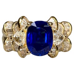 Anello cocktail con zaffiro ovale e cuore a baguette con diamante 5,63cttw