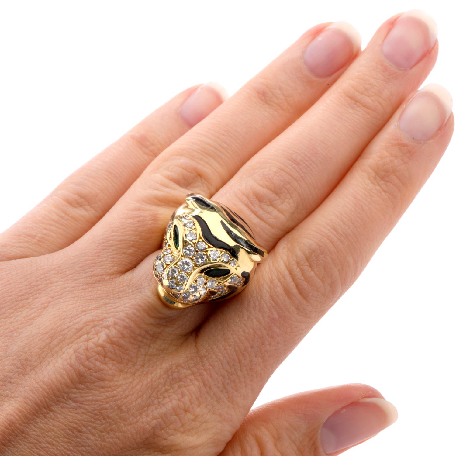 This striking cocktail ring was inspired in a Panther Head motif

and crafted in yellow 18K.

Featuring Marquise shaped Emerald eyes and round brilliant

cut diamonds throughout the face and head.

Vibrant black stripes of enamel offer