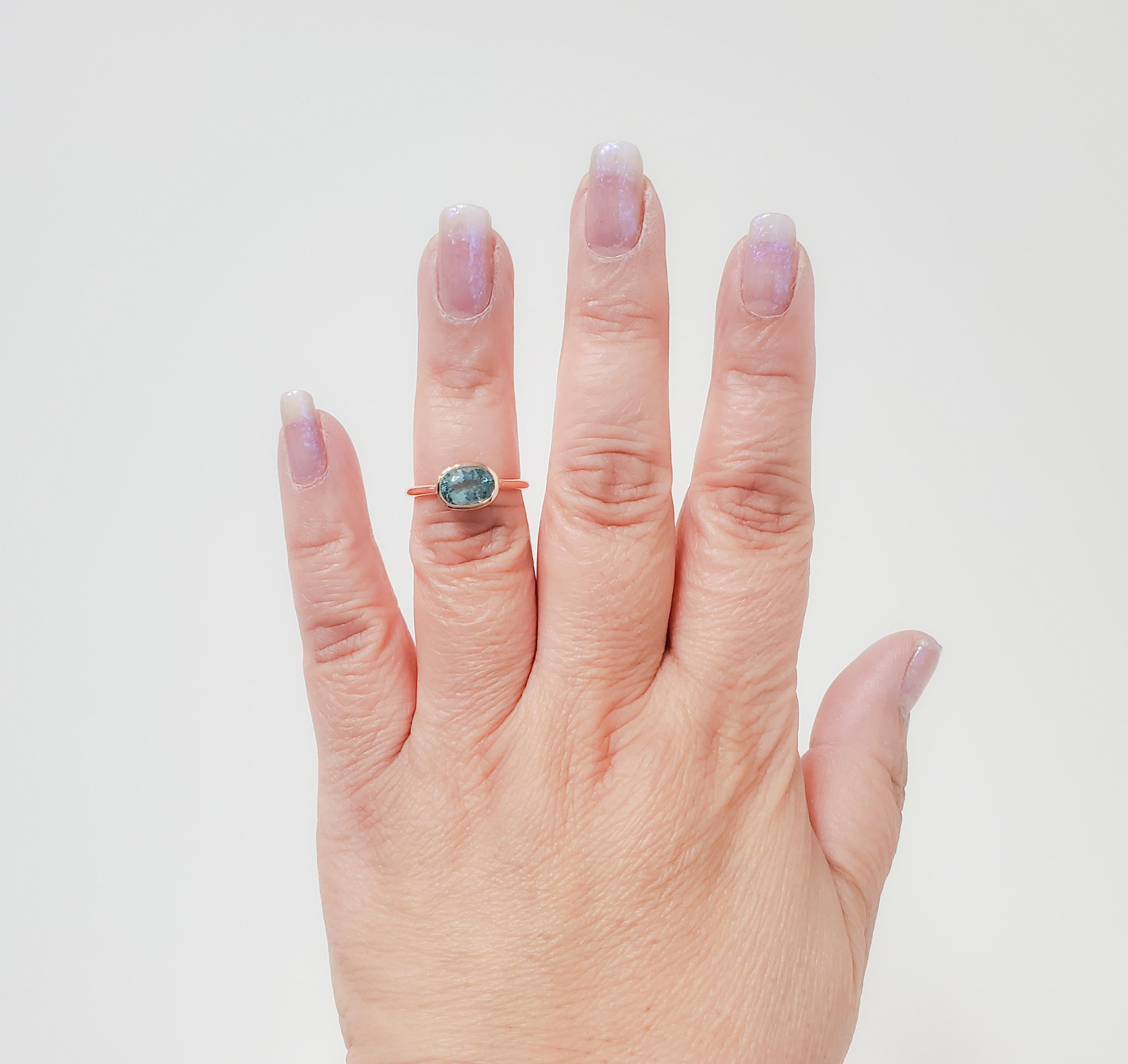 Gorgeous bright 1.40 ct. paraiba tourmaline oval in a handmade 18k rose gold mounting.  Ring size 6.75.