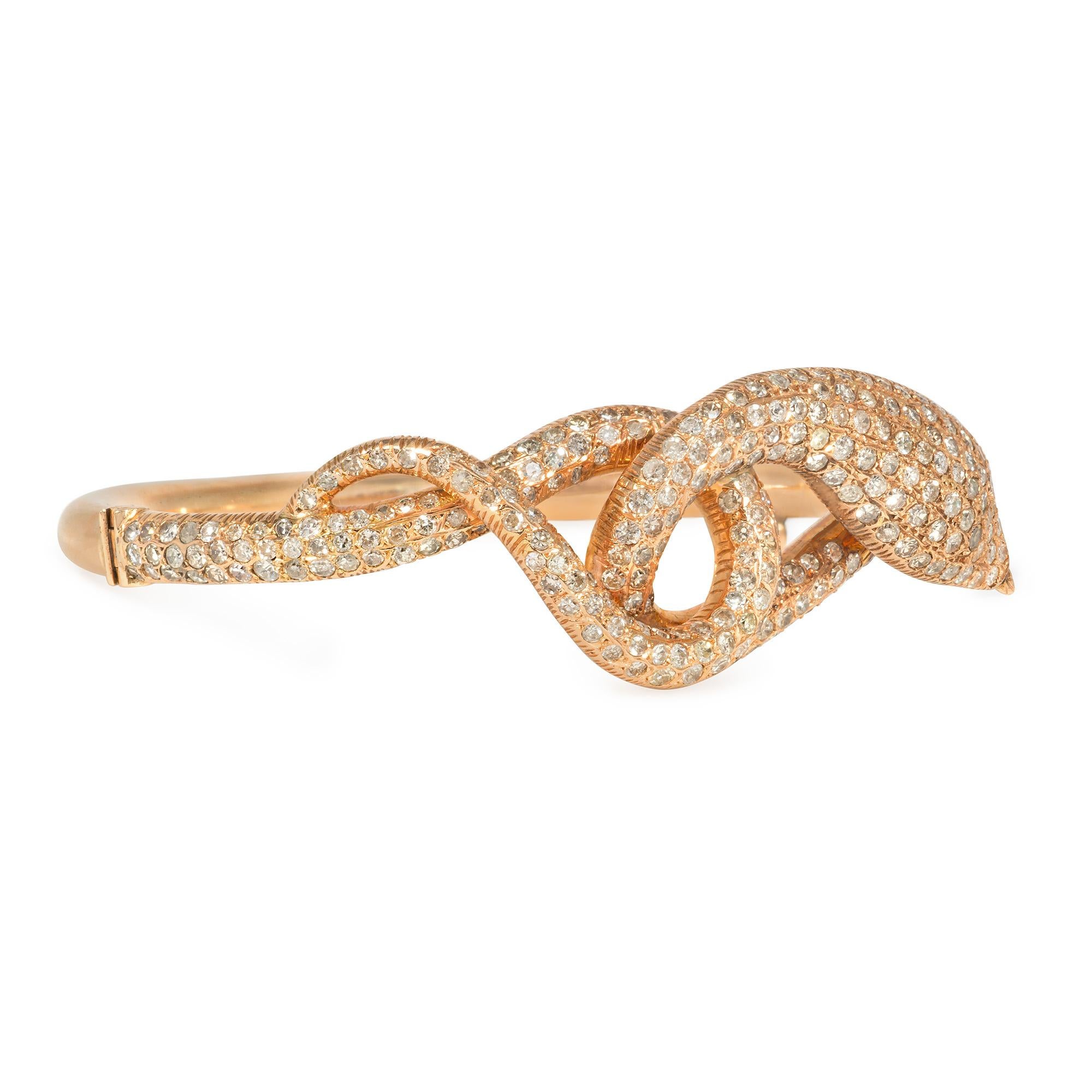 A Mid-Century rose gold and pavé diamond hinged bangle bracelet in the form of a coiled snake, set with single-cut diamonds on the front, in 14k.  Atw diamonds 4.00 cts.  Dimensions: 6.5