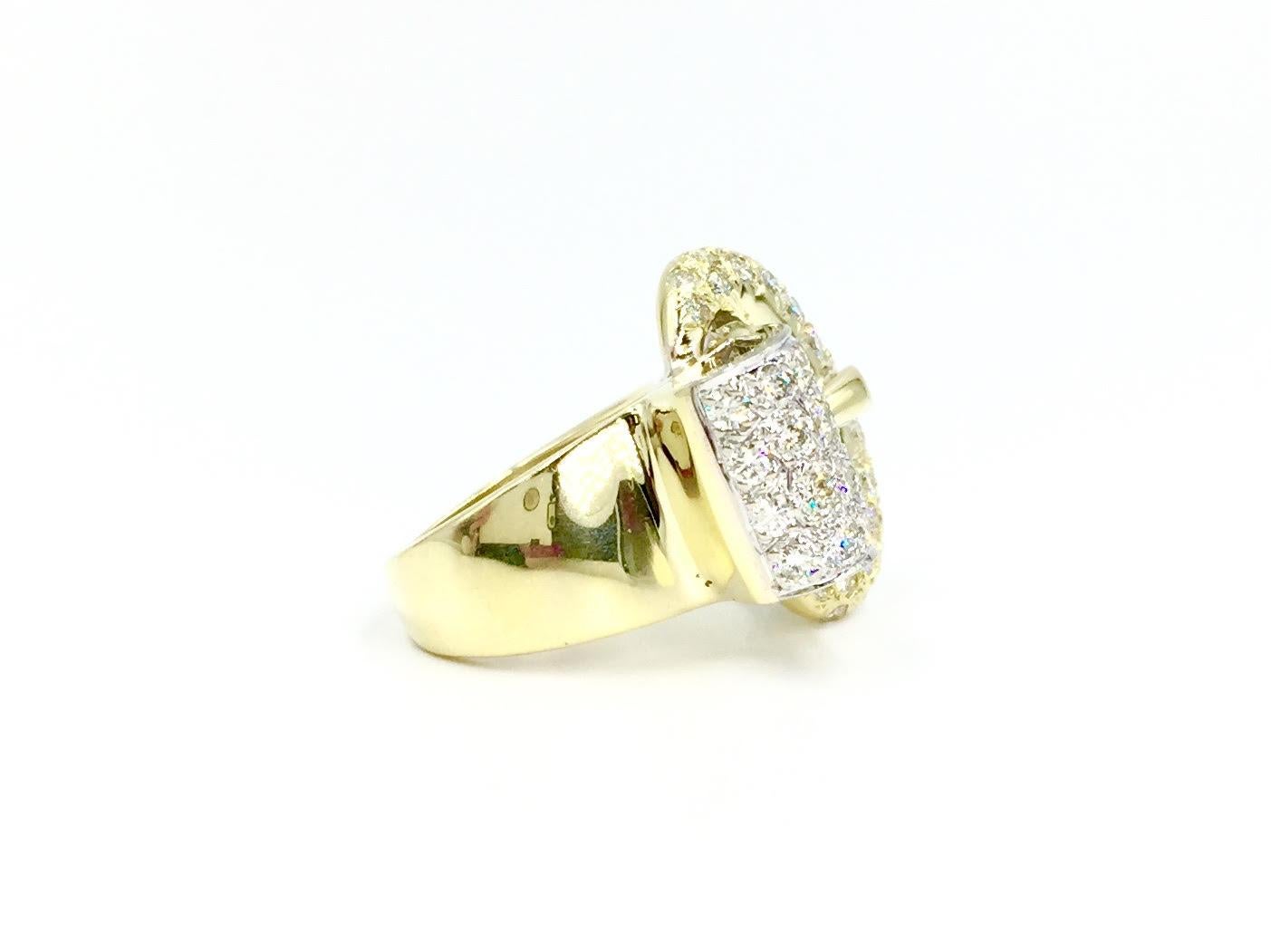 This bright and beautiful 14 karat two tone gold buckle ring features approximately 2.25 carats of round expertly set pavé diamonds. Diamonds are approximately F color, VS2 clarity with a generous amount of sparkle. 
Top white gold section of ring