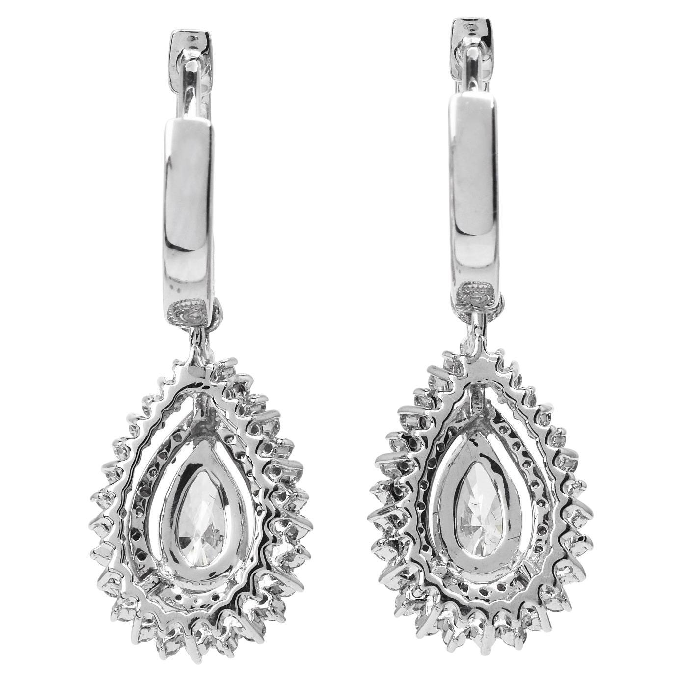 A romantic drop of beauty emerges with these exquisite earrings.

These sparkly pieces are decorated from top to bottom with a dance in genuine Diamonds. The center diamond pears are 0.83 carats, J color & VS clarity.

Secured by a