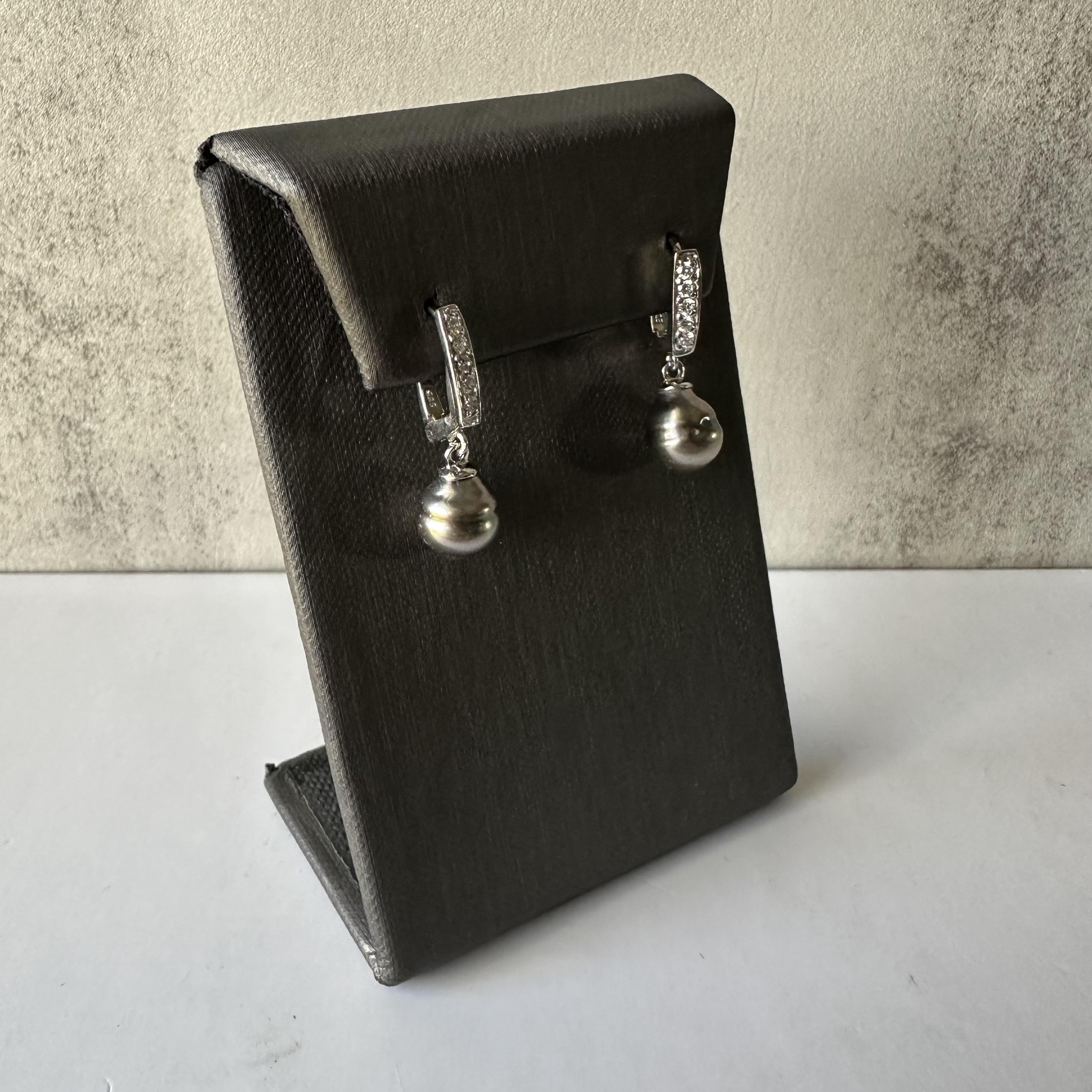 Enhance your collection with these exquisite Drop Earrings featuring Pearls and Diamonds in 14k White Gold. The elegant design showcases lustrous pearls, complemented by 0.25 carats of round cut diamonds. Crafted in 14k white gold, these earrings