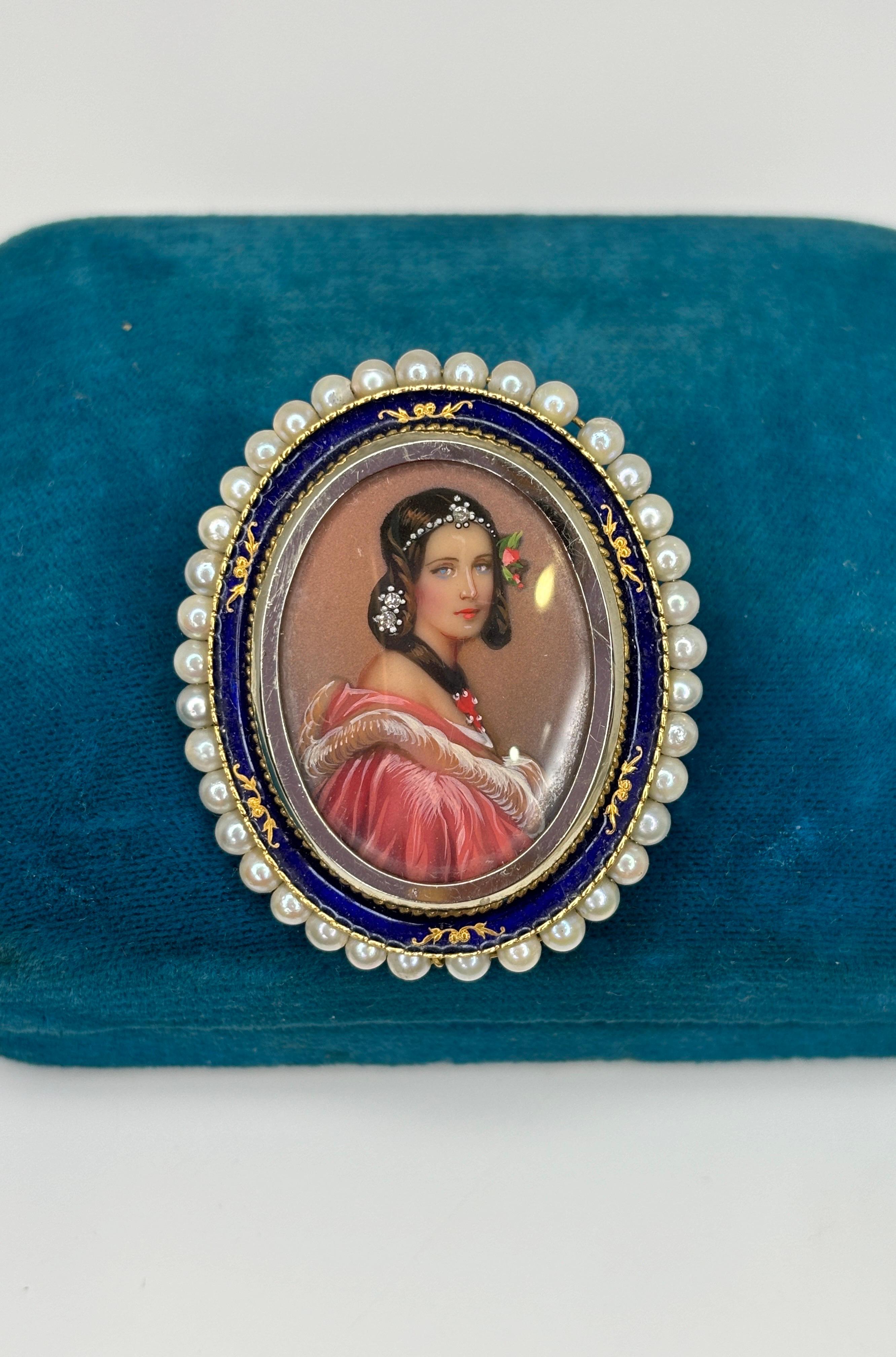 This beautiful piece can we worn as a brooch or on a chain as a pendant. This unique piece features a hand-painted portrait of a beautiful young woman with rose colored gown and gems decorating her hair. The little beauty is surrounded by blue