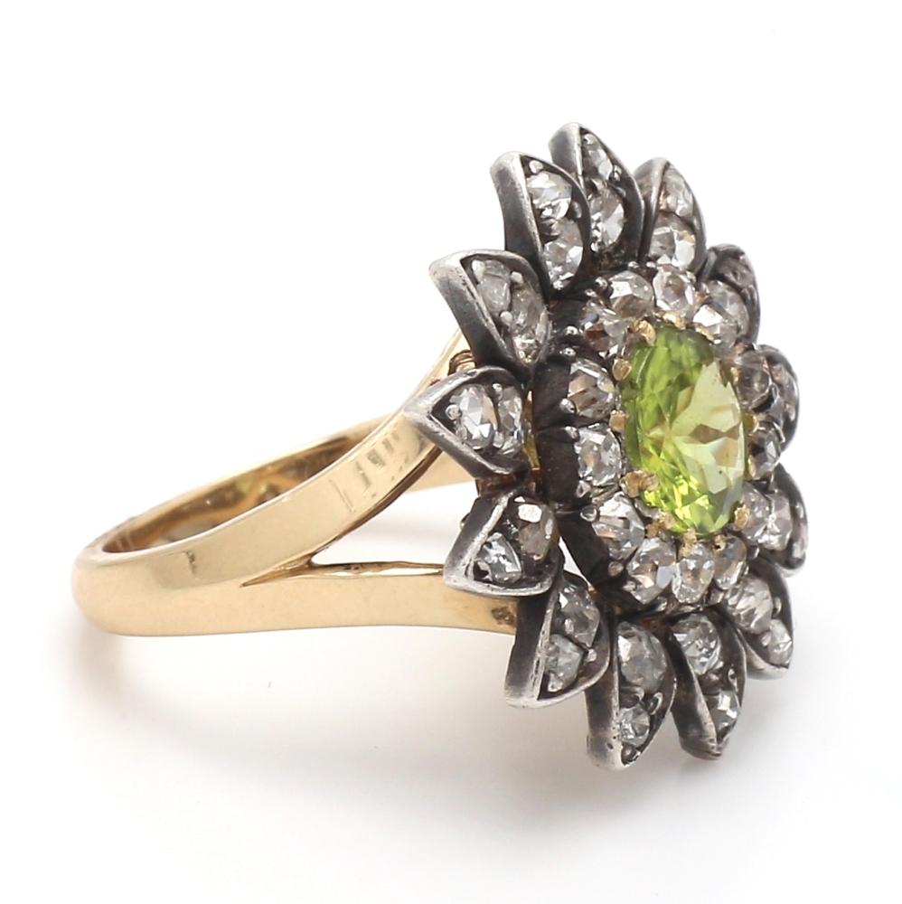 14K yellow gold and silver ring. Center stone is one (1) round brilliant cut peridot weighing 1.35ct. Ring is set with thirty-eight (38) round brilliant cut diamonds weighing approximately 2.30ctw. Ring 7.9 grams and is a size 6.5. 
All questions