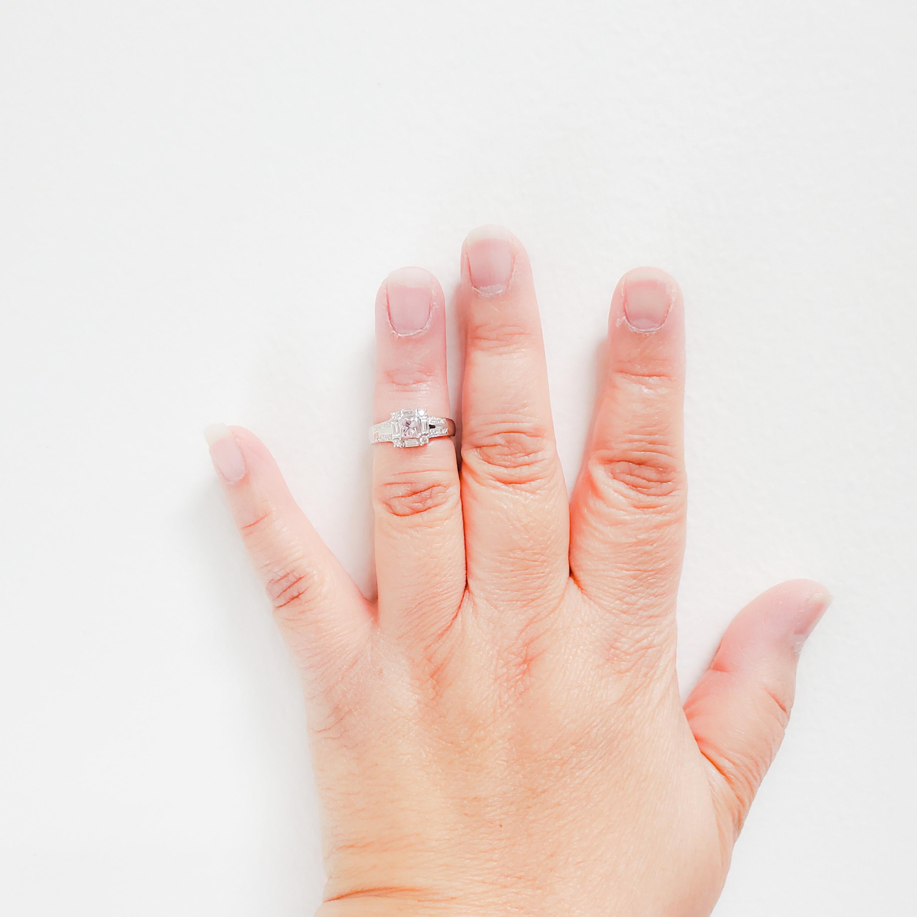 Beautiful natural pink diamond princess cut weighing 0.42 ct. with 0.36 ct. good quality white diamond rounds and baguettes.  Platinum handmade mounting in ring size 5.