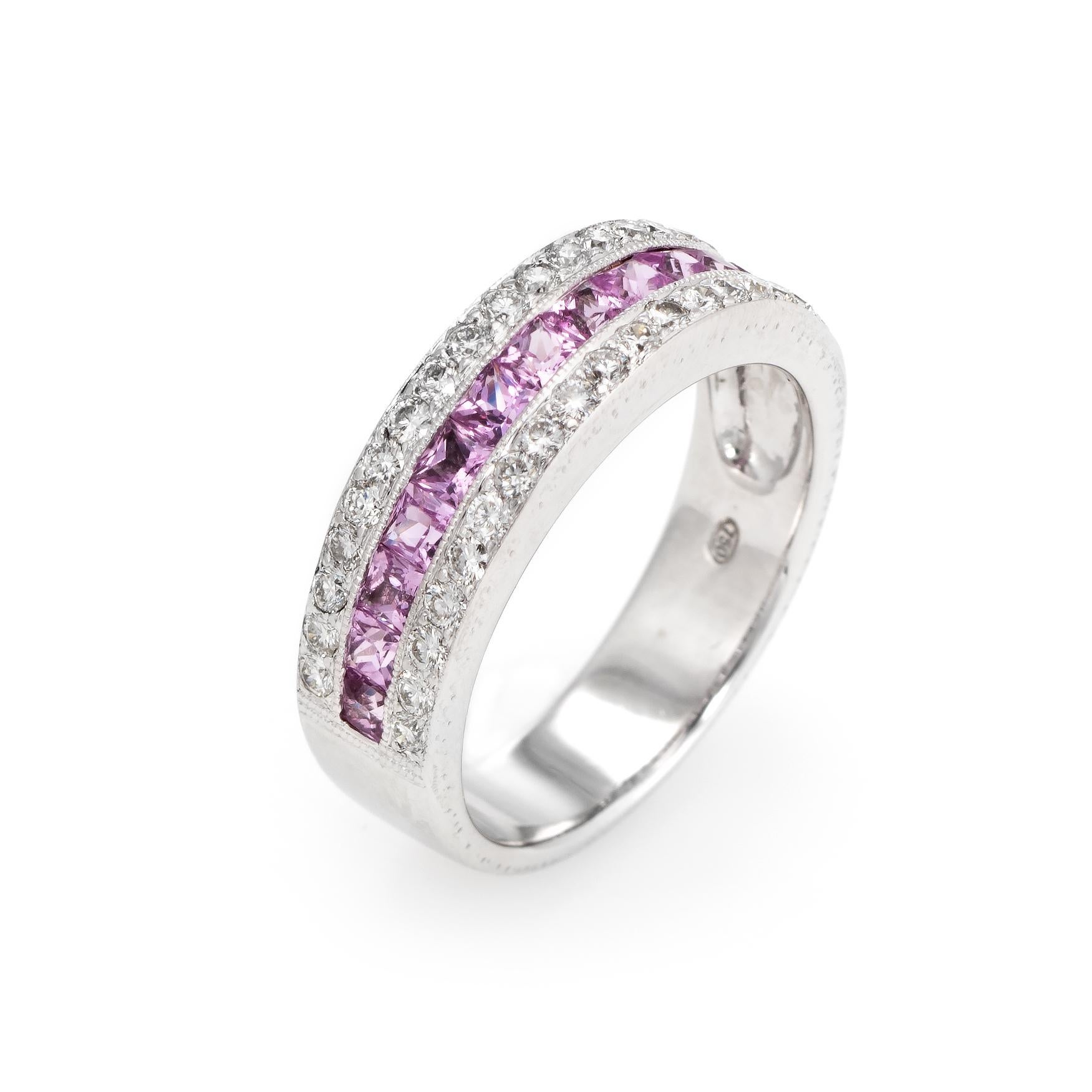 Elegant & finely detailed estate pink sapphire & diamond band, crafted in 18 karat white gold. 

13 centrally mounted princess cut pink sapphires are estimated at 0.05 carats each and total an estimated 0.65 carats. 36 round brilliant cut diamonds