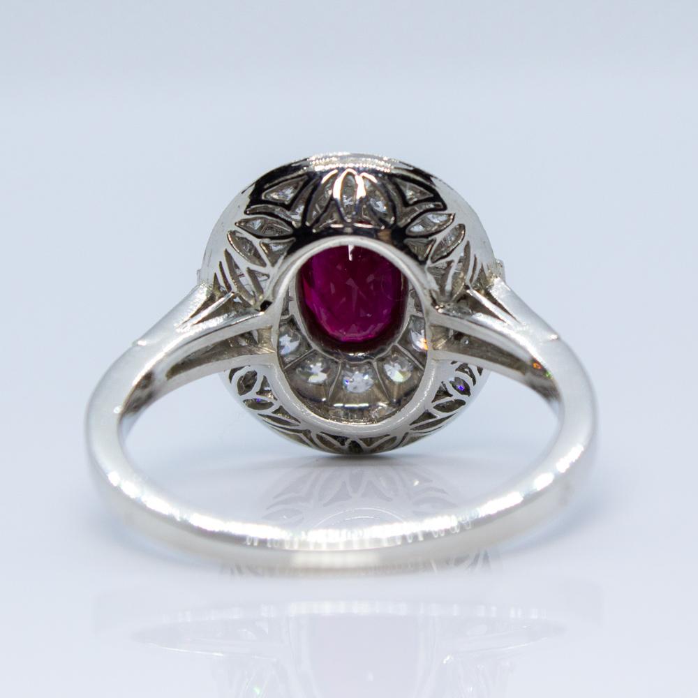 Composition: Platinum
Stones:
•	1 natural Burma oval cut ruby that weighs 1.20ctw.
•	4 baguette cut diamonds of H-VS2 quality that weigh 0.60ctw. 
•	26 Old mine cut diamonds of H-VS2 quality that weigh 0.70ctw.
Ring size: 7    
Ring face:  15mm by