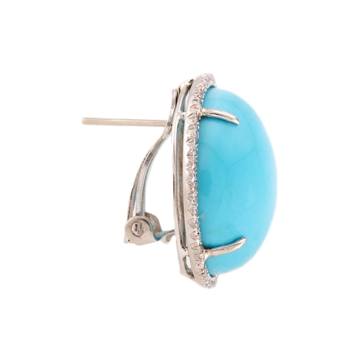 A fantastic pair of Estate turquoise earrings! These fabulous earrings are crafted in platinum and have a simple yet bold design. Each earring features a large turquoise stone in the center, surrounded by a border of sparkling diamonds. The