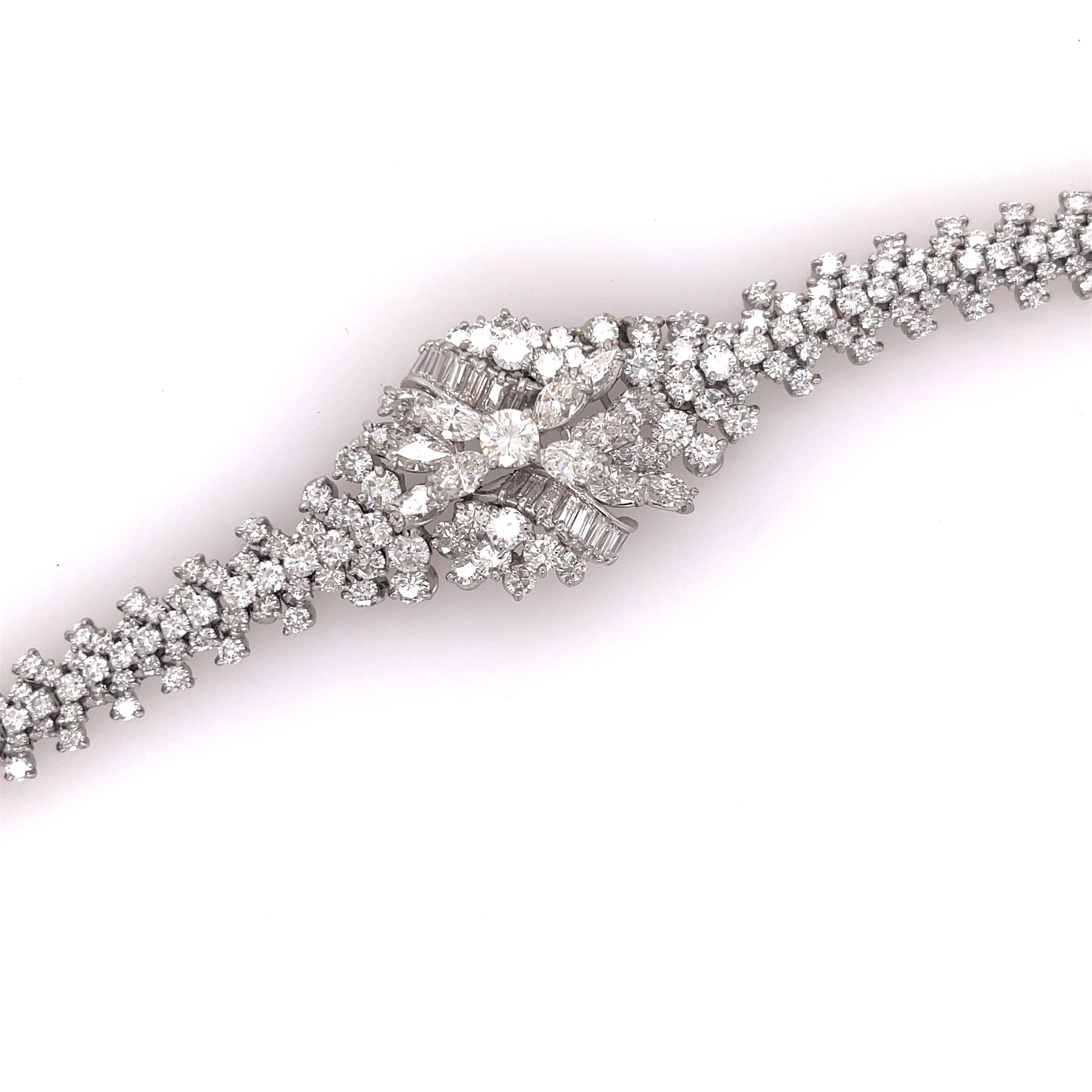 Estate diamond bracelet set in platinum. The bracelet features 17.15ctw of round, baguette, and oval diamonds. 