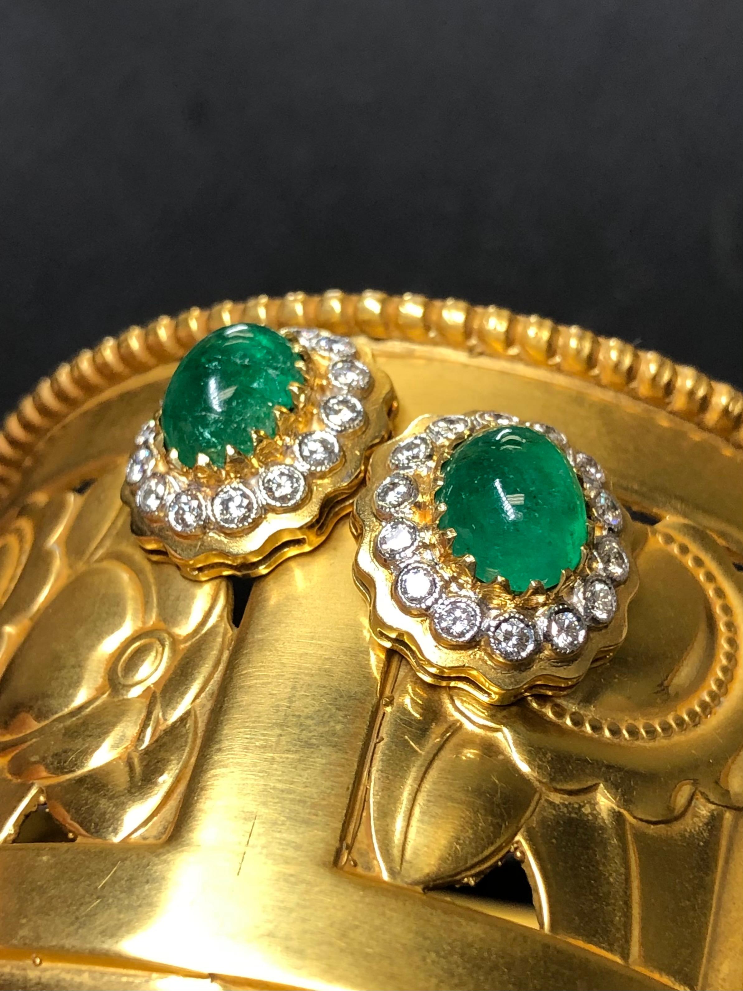 A sensational pair of earrings done in 18K yellow gold and platinum, prong set with approximately 1.40cttw in F-G color Vs1+ clarity round diamonds and centered by 4ct EACH (8cttw) natural cabochon emeralds exhibiting gorgeous color (photos are