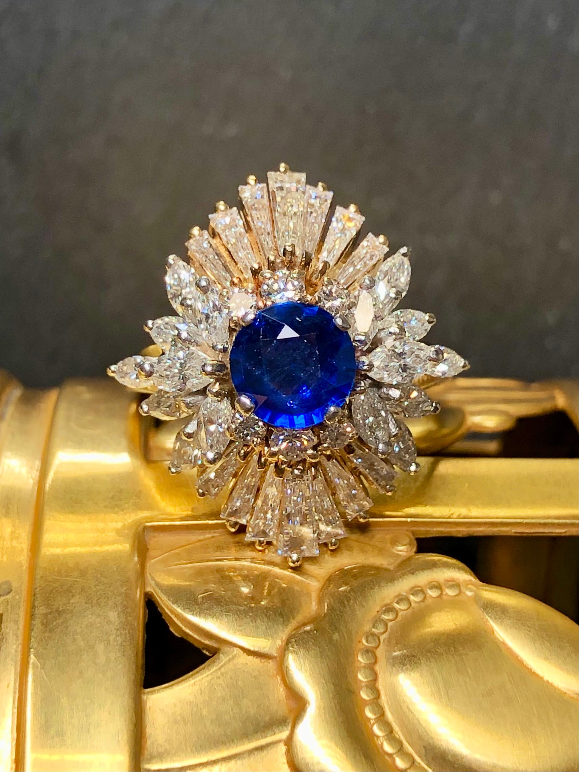 
A fabulous cocktail ring hand done in platinum and 18K yellow gold centered by an approximately 1.63ct royal blue natural Ceylon sapphire (with GIA report) surrounded by absolutely gorgeous tapered baguette, marquise and round diamonds having a