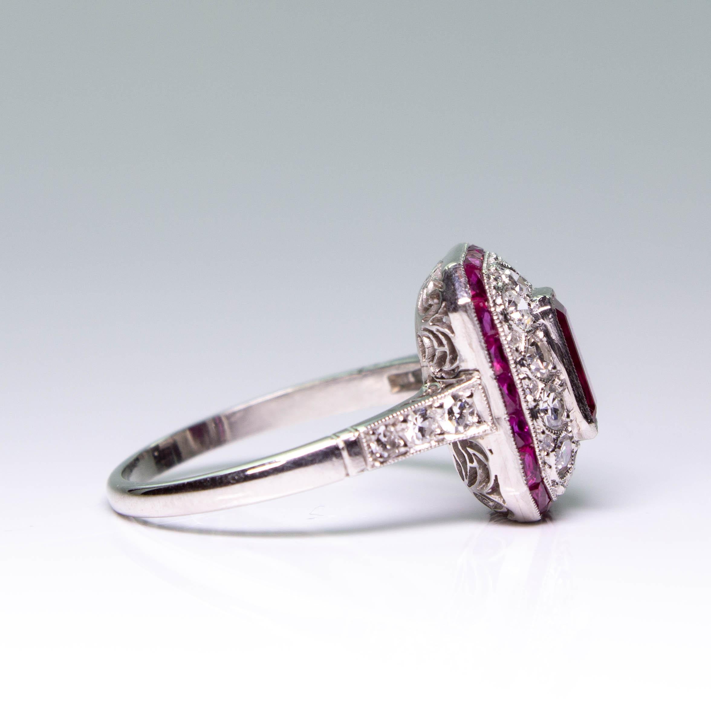 Composition: Platinum
Stones:
•	1 natural Emerald cut Burma Ruby that weighs 1.25ctw.
•	30 Single cut diamonds of H-VS2 quality that weigh 0.74ctw. 
•	22 natural French cut rubies that weigh 0.80ctw.
Ring size: 7 ¾    
Ring face:  14mm by 12mm 
Rise