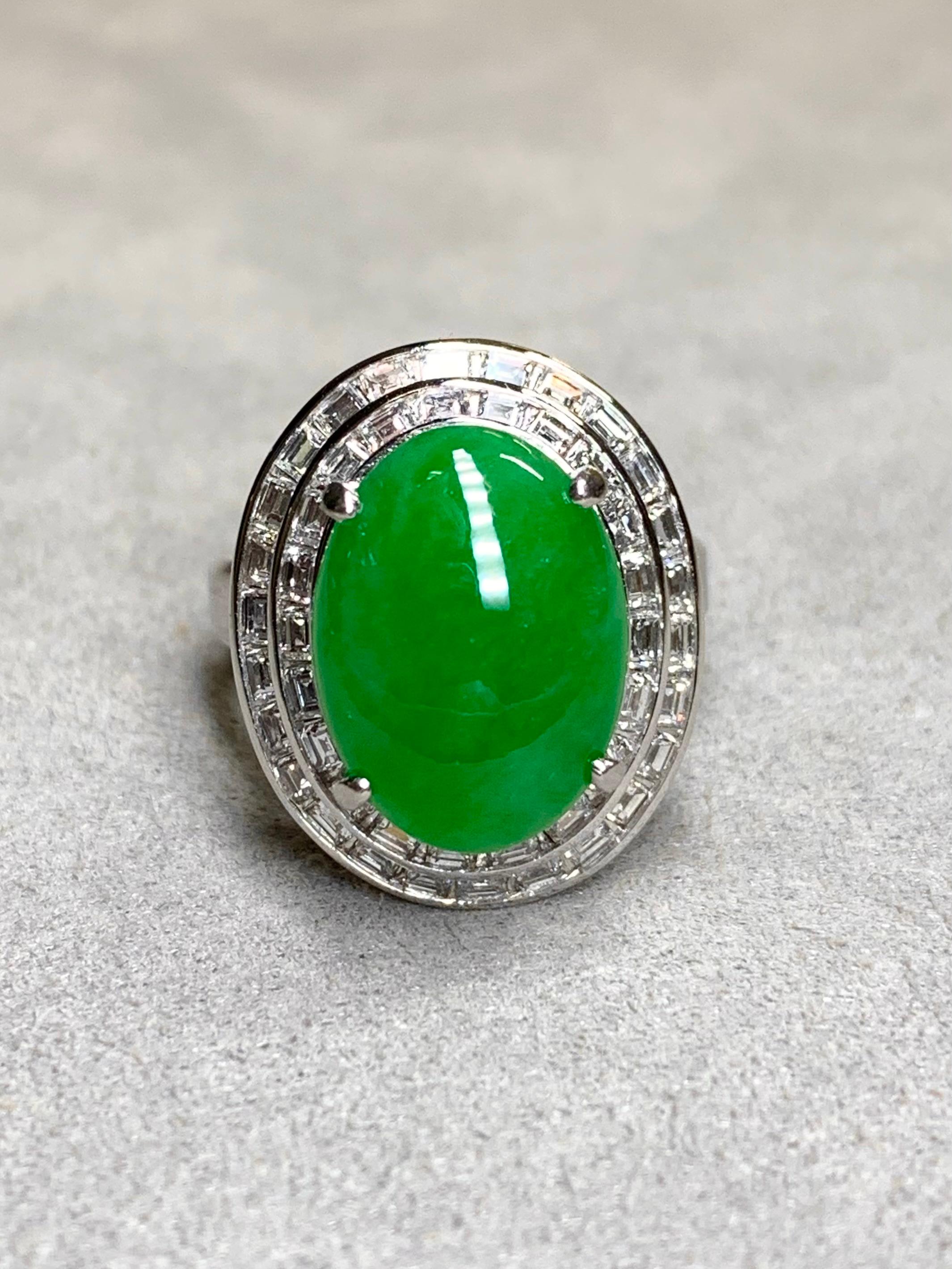This simply stunning cocktail ring is centered by a 13.10ct natural “A” jade cabochon surrounded by approximately 2.35ctw in G-H color Vs1+ clarity square baguette cut diamonds. The shank has a beautiful high-polish with satin finish center setting