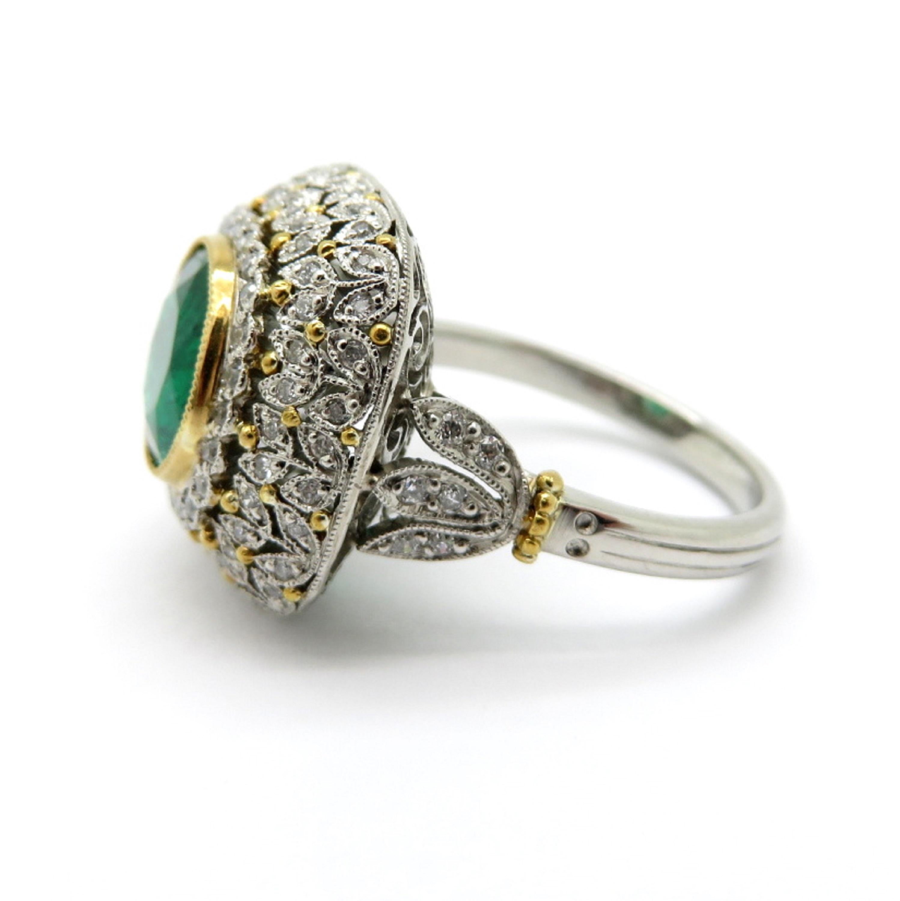 For sale is an Estate Platinum and 18K Yellow Gold Victorian Diamond & Emerald Flower Ring!
Showcasing one round brilliant cut fine quality Emerald weighing 3.07 carats.
Accented by numerous round brilliant cut diamonds, bead set, weighing a