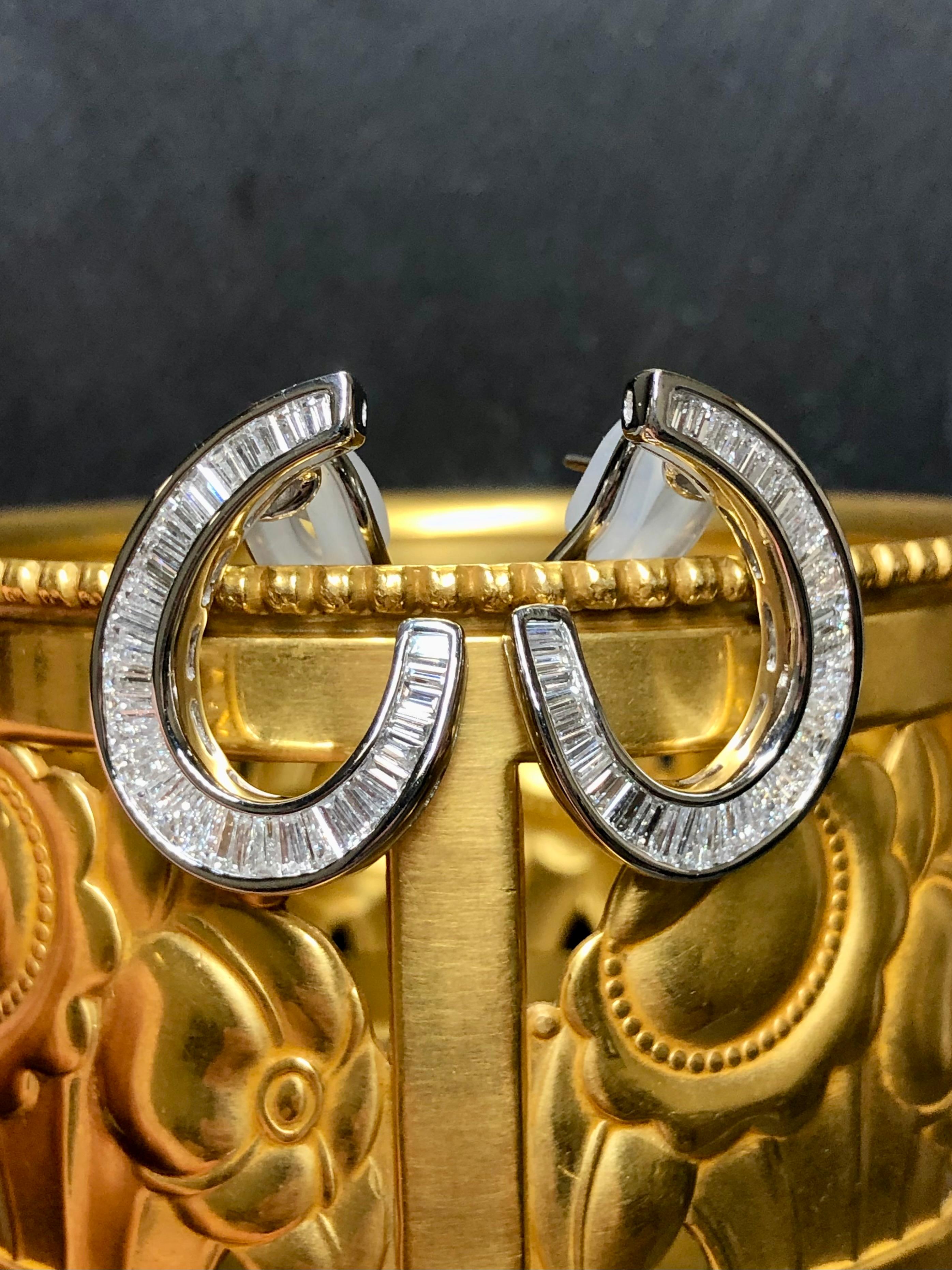 A classic pair of finely made earrings done in platinum and channel set with 66 straight and tapered baguette diamonds. All stones are G-H color and Vs1 clarity with a total approximate weight of 3.90cttw. Earrings has posts with omega