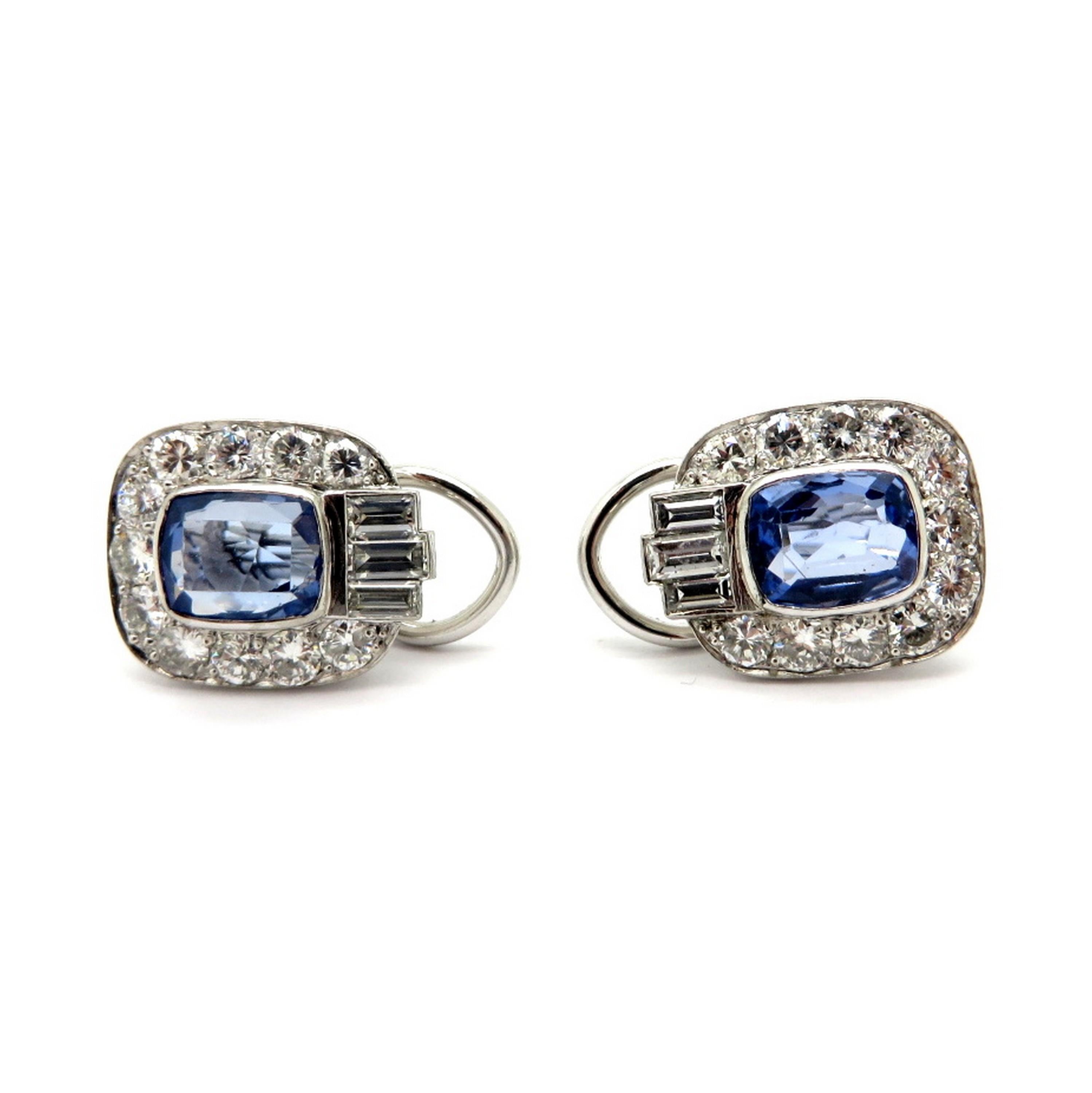 Estate platinum ceylon sapphire, round, and baguette diamond clip on earrings.  Showcasing two bezel set fine quality ceylon blue cushion cut sapphires weighing approximately 3.00 carats total.  Accented with 22 round brilliant cut micro prong set