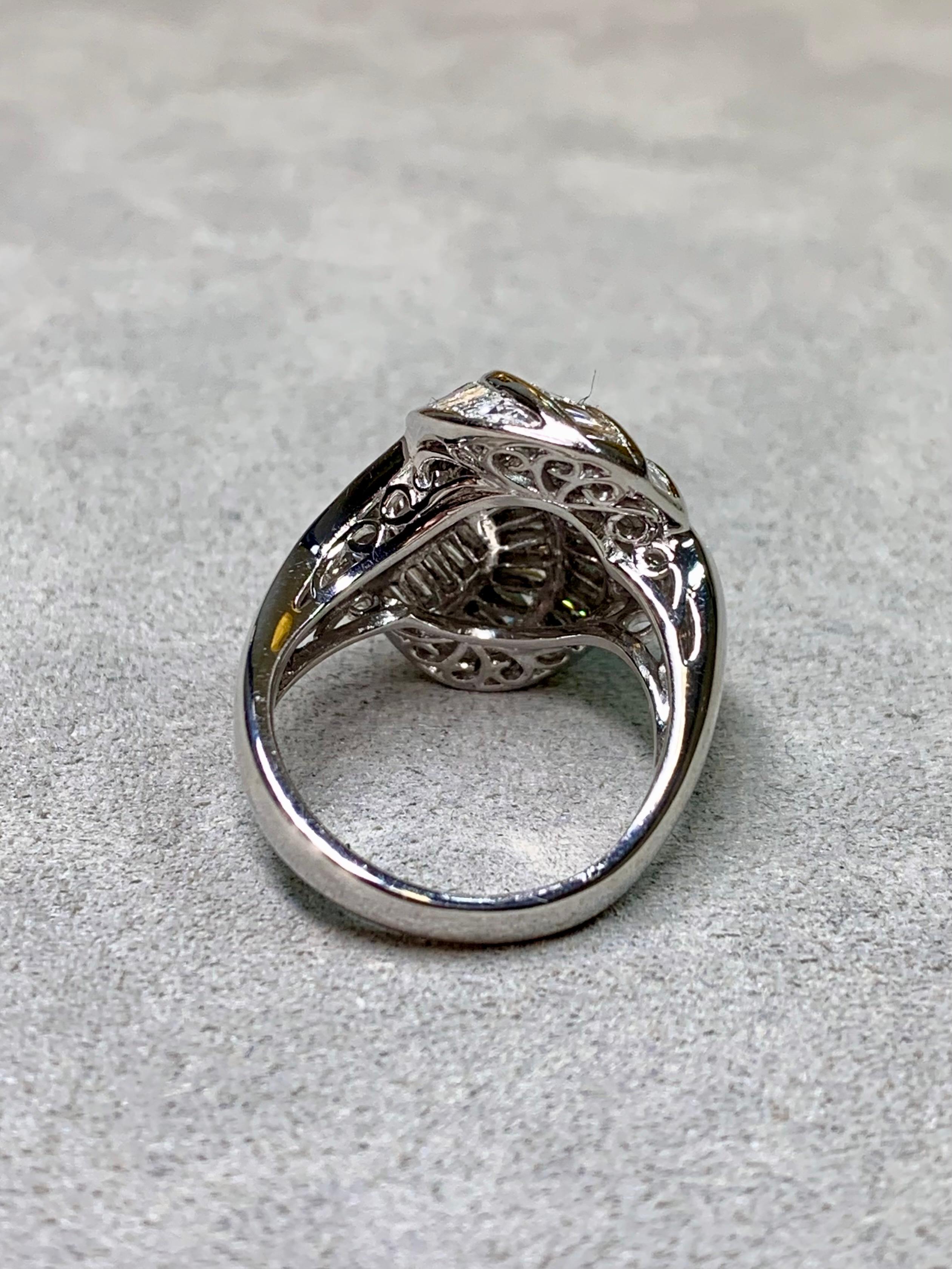 A bold and timeless platinum cocktail ring, showcasing exceptional craftsmanship and sparkle. This striking design features 4.83 carats of shimmering baguette-cut diamonds, elegantly channel set in a wide, tapered form that hugs the finger with