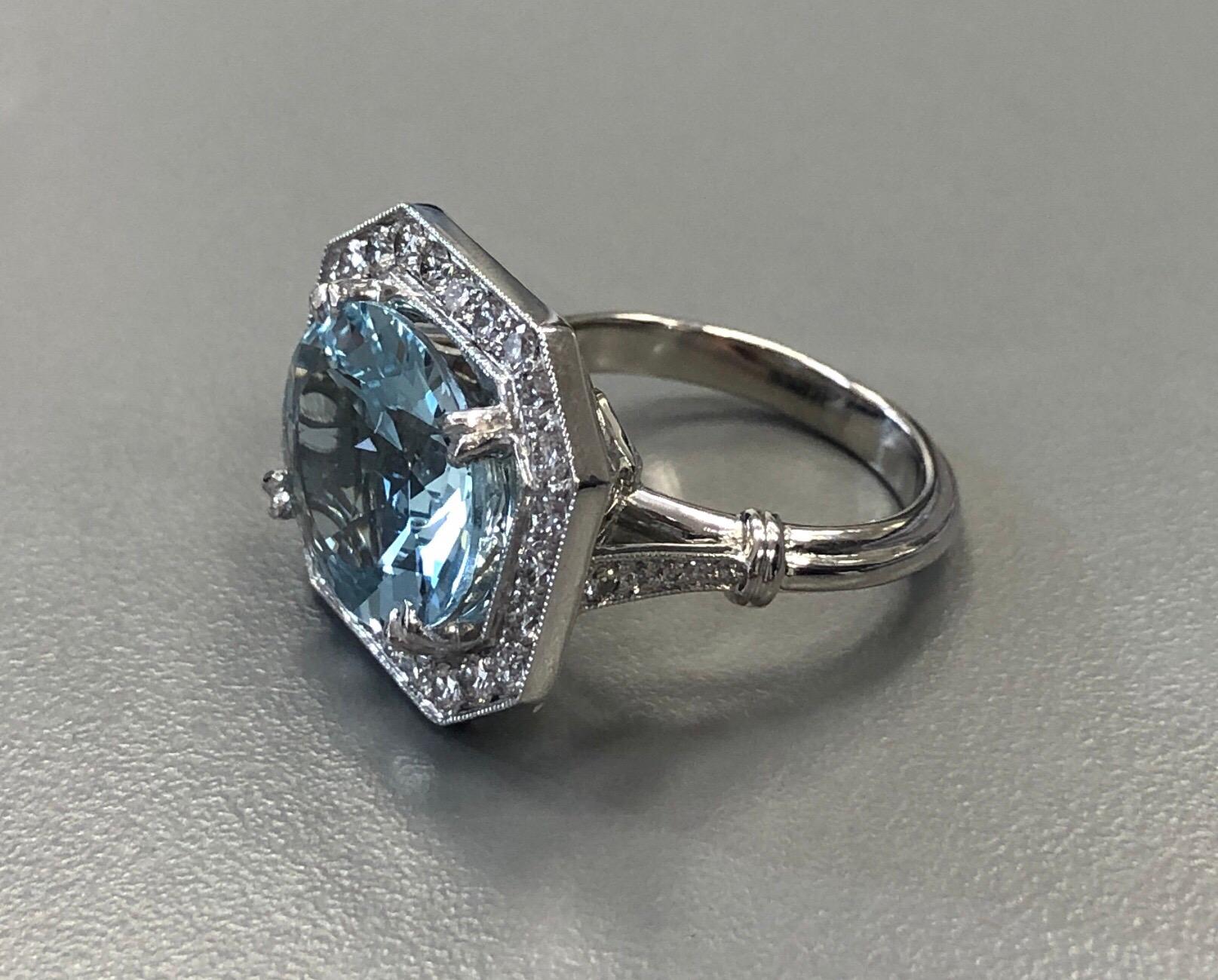 The estate platinum diamond and aquamarine ring, is centered on an approximately 6 carat extremely fine oval mixed cut aquamarine that is exceptionally brilliant. It is set with approximately 1 carat full cut fine diamonds.