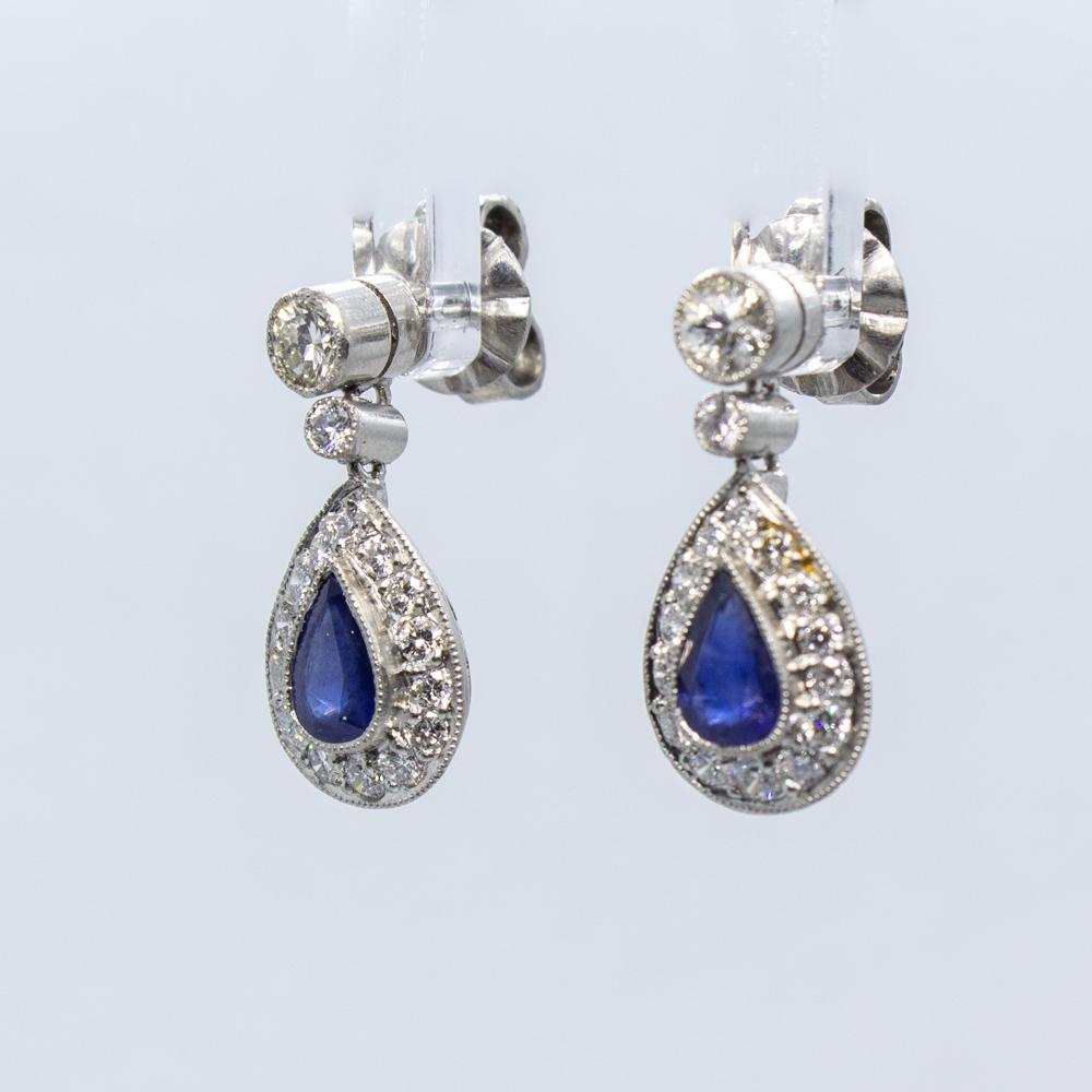 Composition: Platinum.
Stones:
•	2 natural pear shape sapphires that weigh 1ctw.
•	32 Old European cut diamonds that weigh 0.75ctw. 
Earrings measure: 19mm by 9mm 
Thick: 5mm
Total weight: 4.6grams – 3dwt .
This is an enchanting pair of earrings,