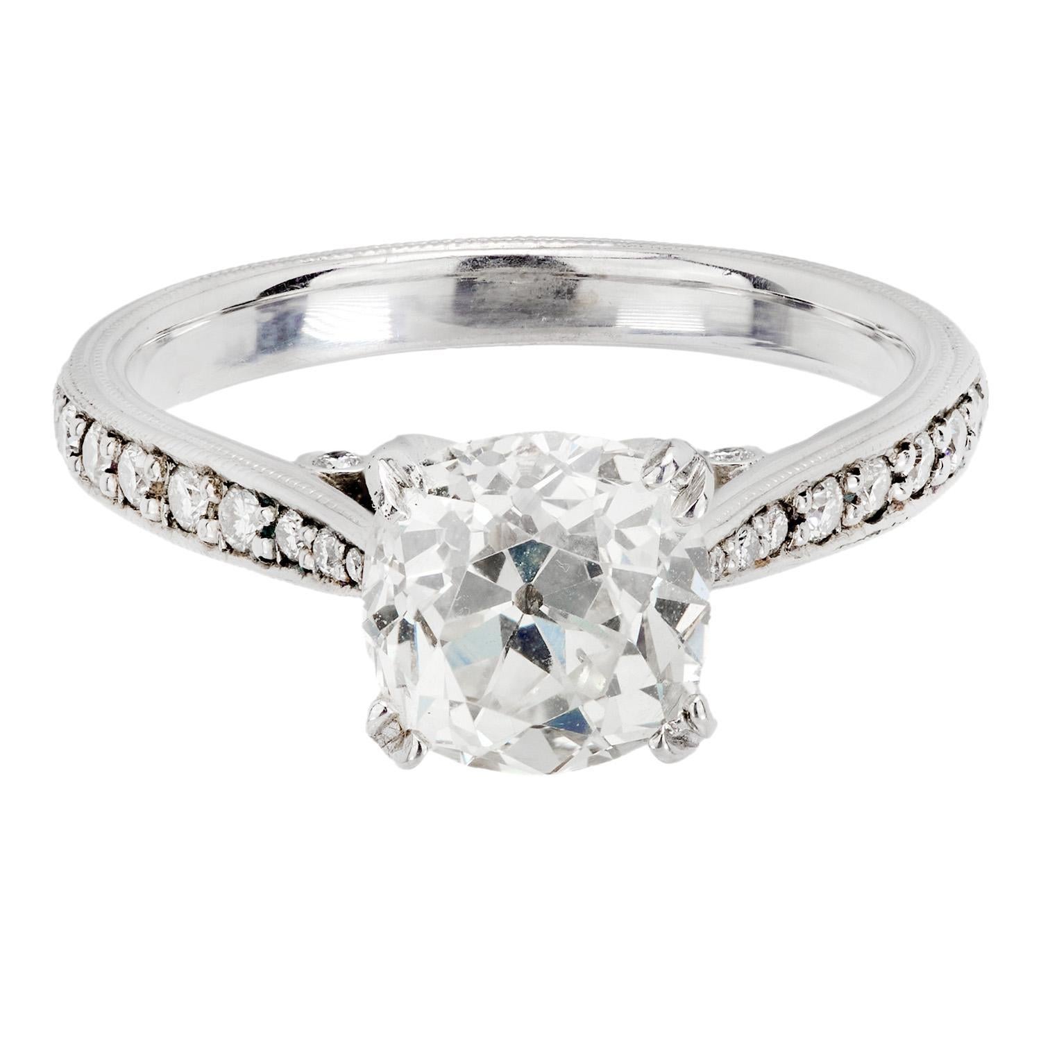 A stunning diamond engagement ring! Crafted in platinum, this ring features a central 2.05ct old mine cut cushion cut diamond, which is held within a four-prong setting. The stone displays J color and VS2 clarity. Each shoulder of the ring is