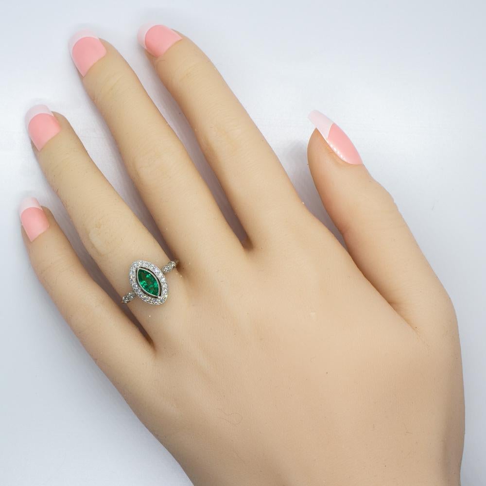 Composition: Platinum
Stones:
•	1 natural Marquise cut Colombian emerald that weighs 0.70ctw.
•	22 Old mine cut diamonds of H-VS2 quality that weigh 0.35ctw. 
Ring face:  14mm by 9mm 
Rise above finger: 5mm.¬
Total weight:  3grams – 1.9dwt¬¬
This