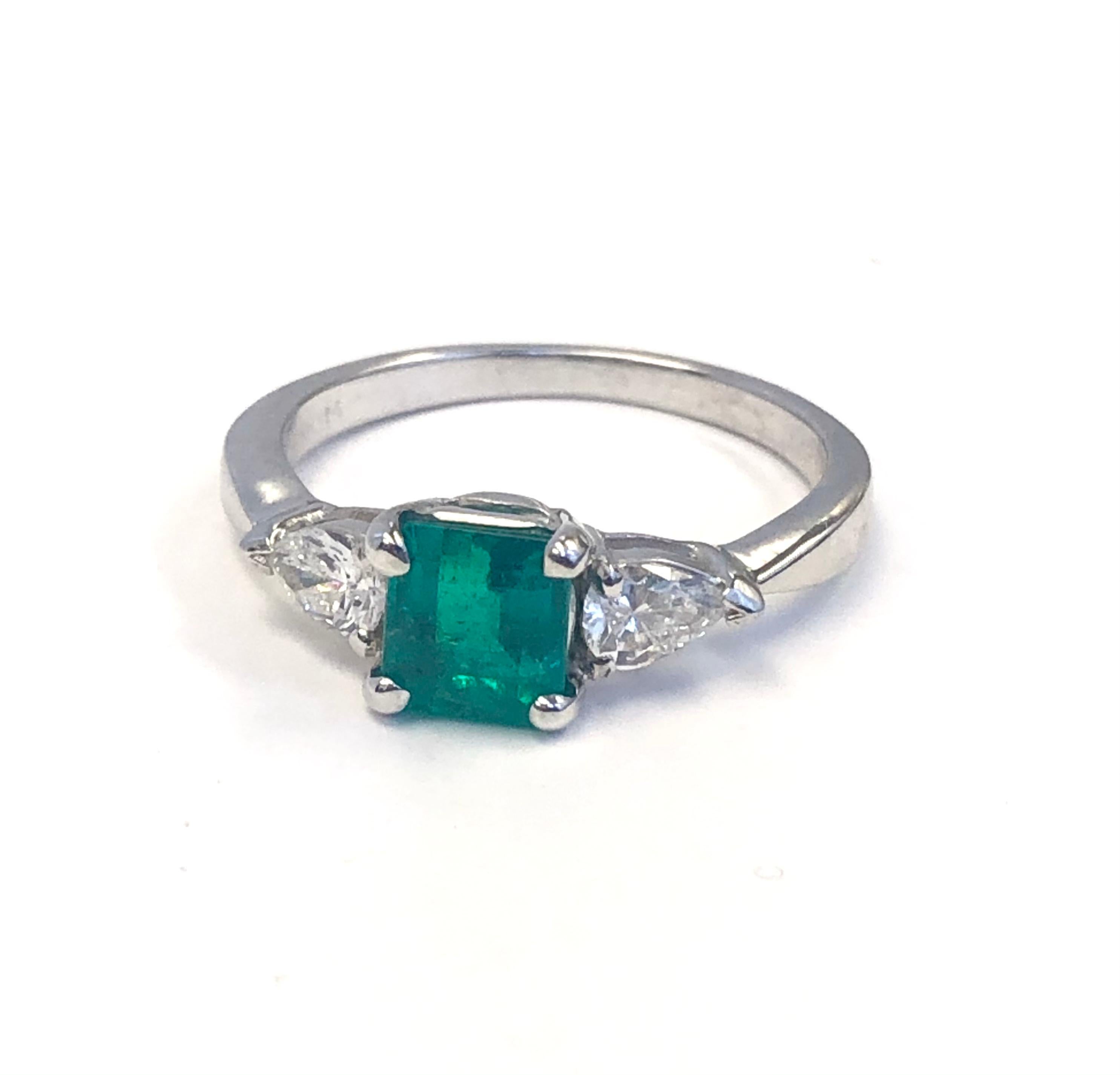 Estate Ring in great condition, made in Platinum, set with two Pear shape Diamonds 0.50 carats and an Emerald Cut Emerald 1.01 carats. Ring size now is a 7, it can be made to your size easily. 