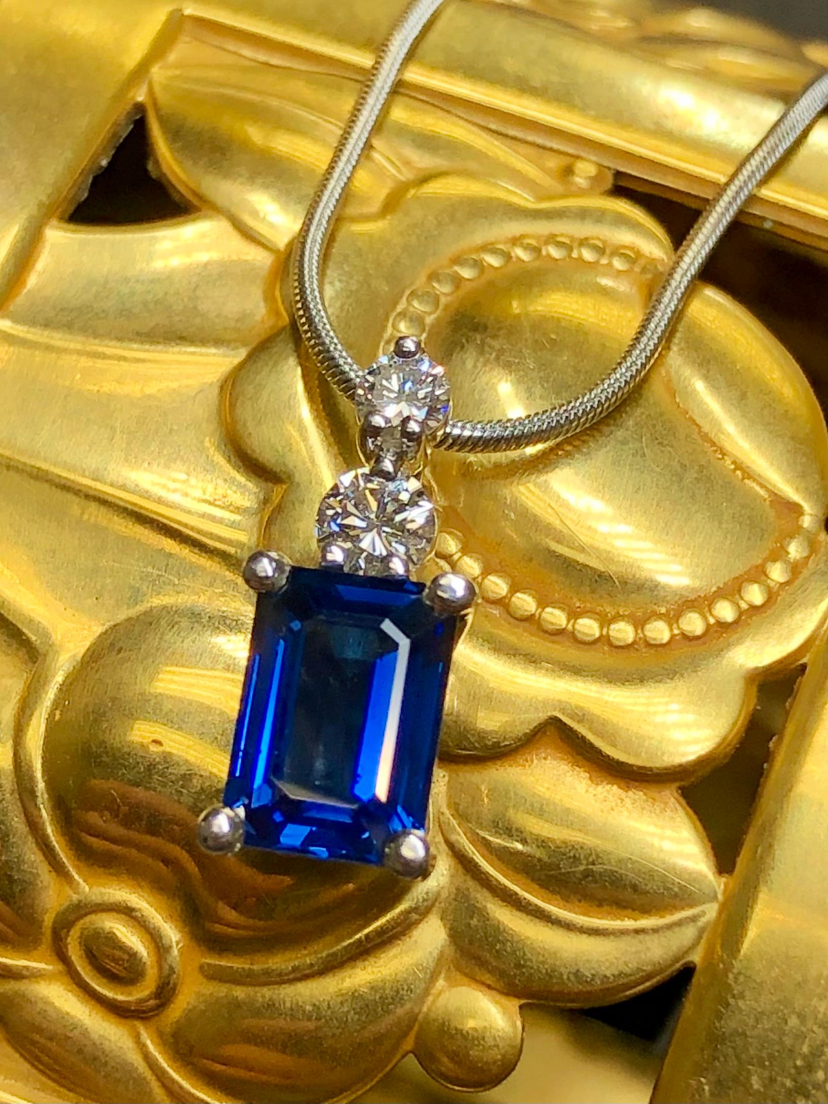 A finely crafted necklace done in platinum (stamped/tested) set with an approximately 1.94ct natural sapphire (w/GIA report) exhibiting a gorgeous royal blue color and absolutely eye and loupe clean! Above the center stone are two .10ct and .15ct