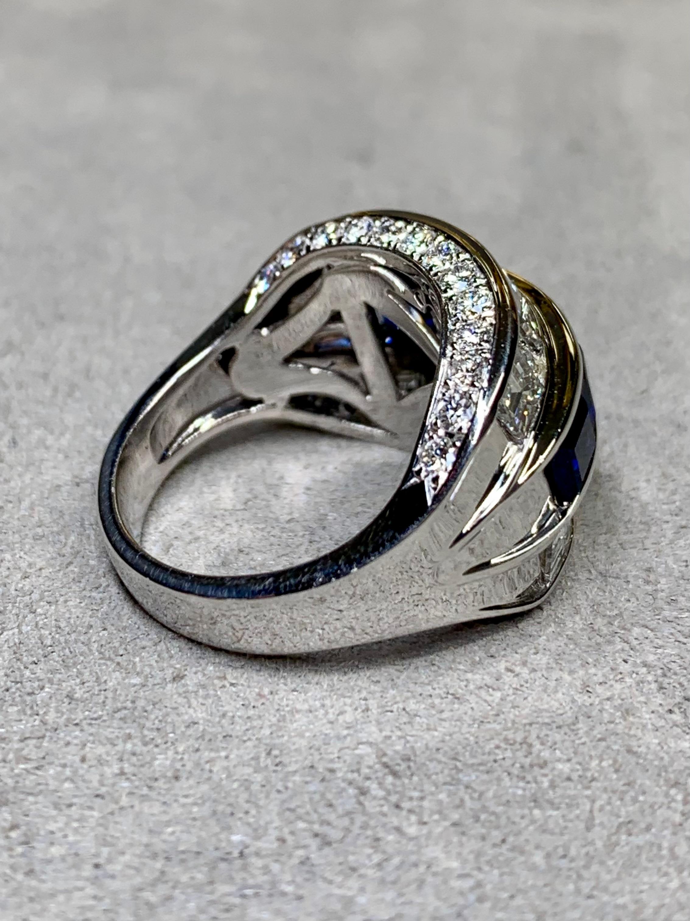 A spectacular wide band ring done in platinum and set with larger, oversized baguette diamonds (.35ct each) ranging G-I in color and Vs1-2 in clarity separated by smaller matching quality round diamonds having a total approximate weight of 3.14ctw.