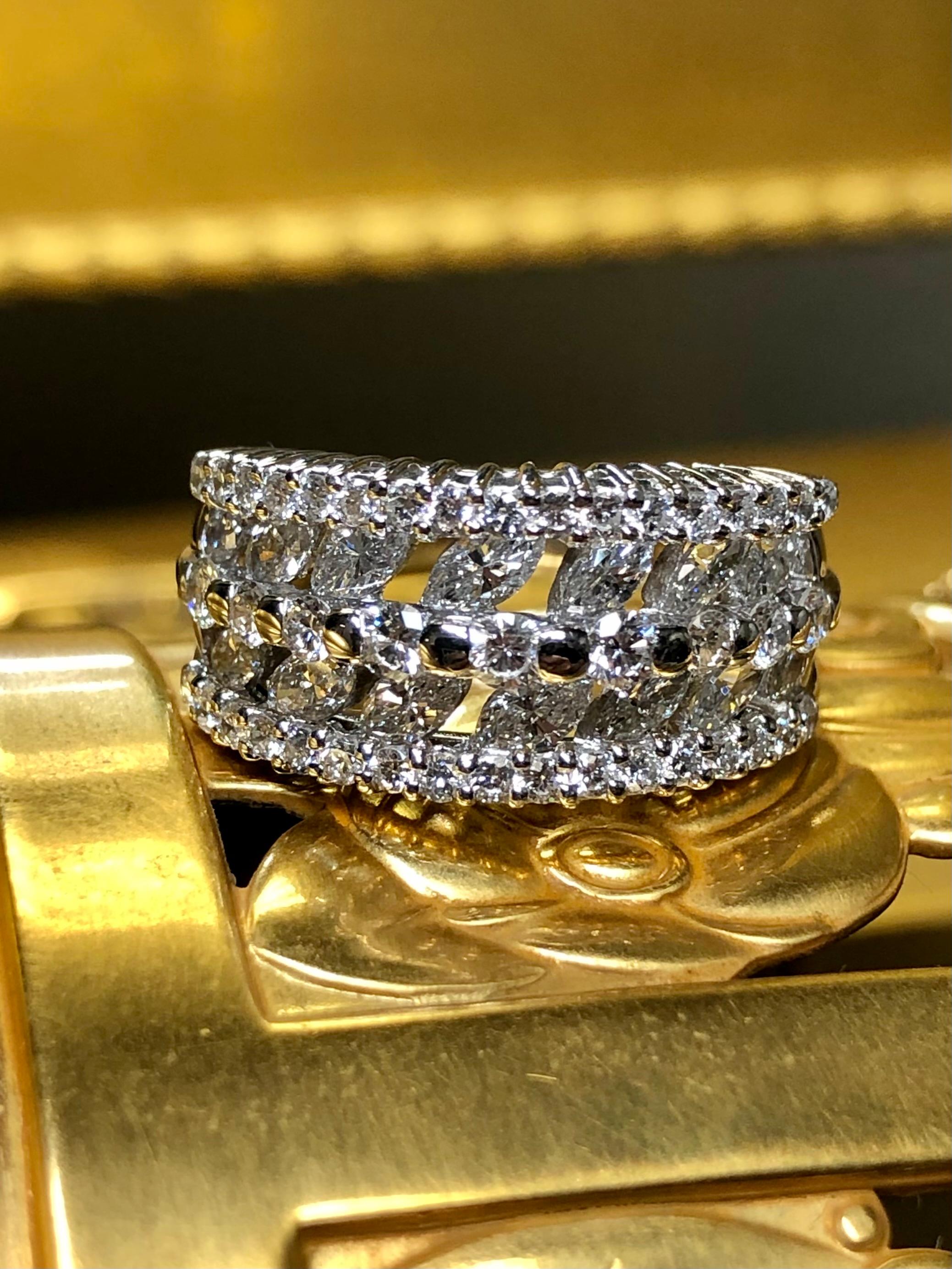 Not all band rings have a presence, but this one most certainly does. Crafted in platinum, this ring has been set with approximately 2cttw in G-I color Vs1-2 clarity round and marquise diamonds in a prong and tension setting. Nicely made and