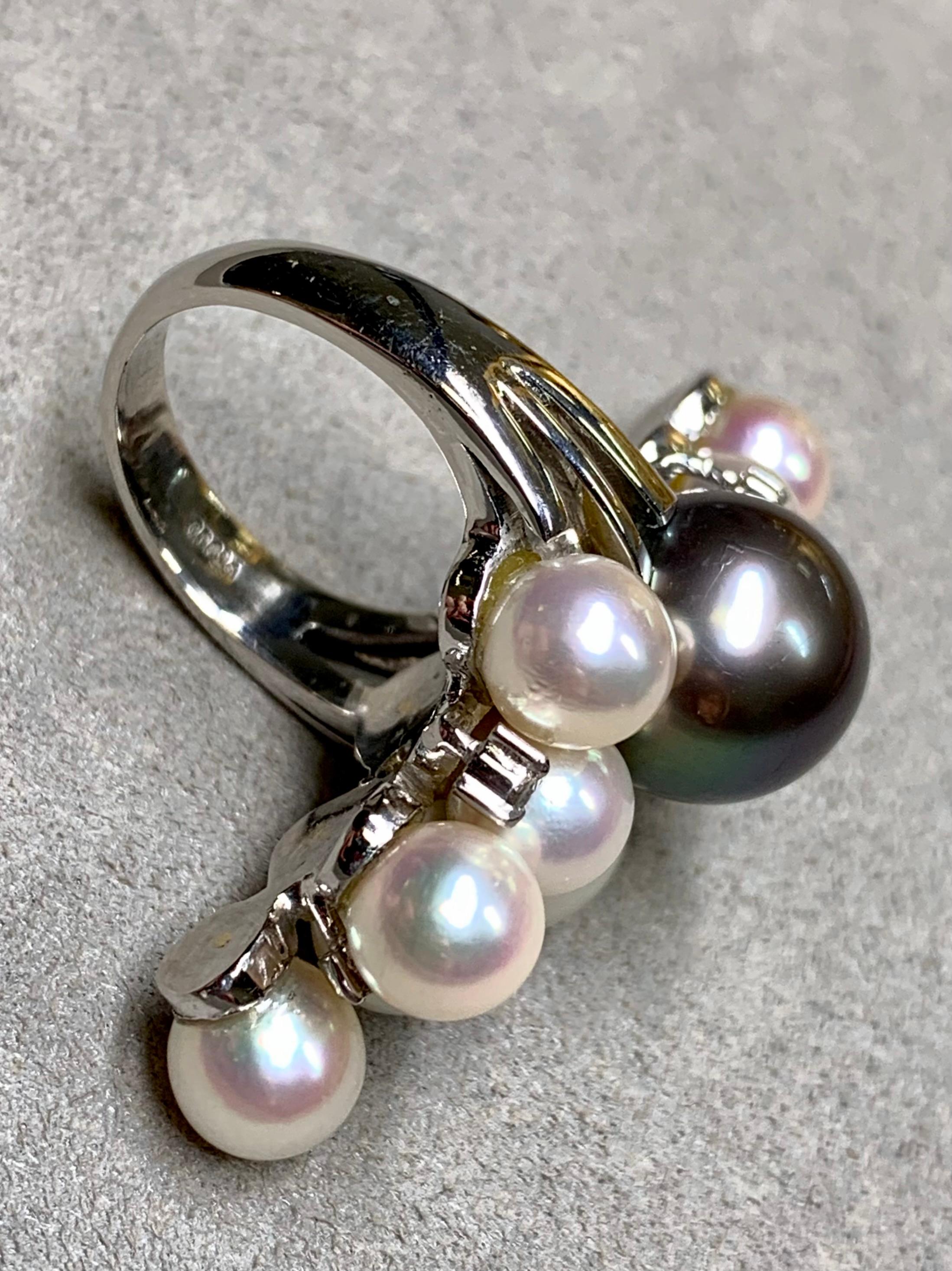 
A unique and dramatic cocktail ring done in platinum and composed of varying sized pearls ranging from 6.50mm to 11.50mm. Sprinkled throughout the pearls are prong set round diamonds totaling approximately .12ctw.


Dimensions/Weight:

Ring