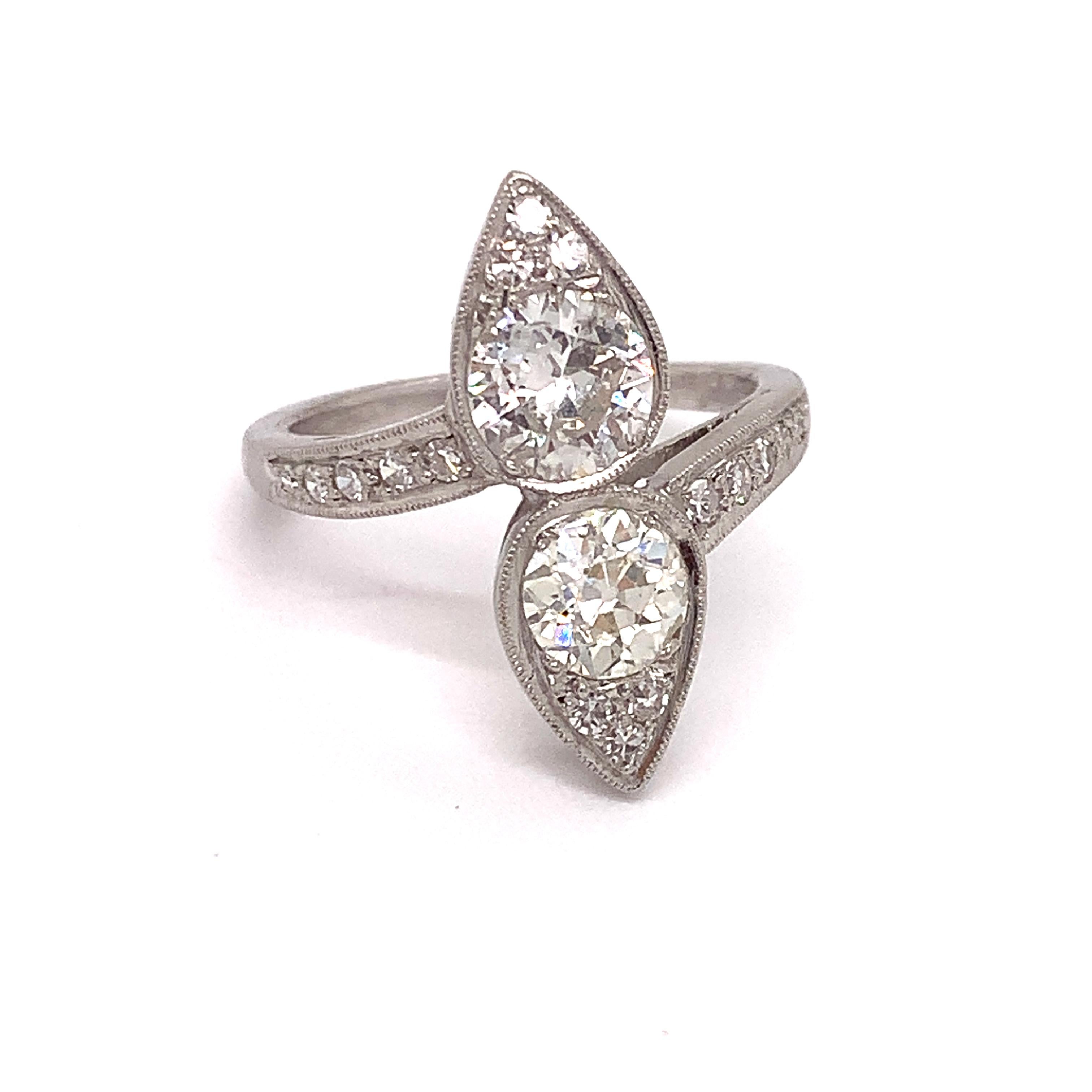 Wear a piece of history! This elegant, elongated estate diamond ring is circa 1930 featuring two Old European Cut diamonds. The first is .70 carats, with SI Clarity and G/H color and the second is .65 carats with SI clarity and G/H color.  There is