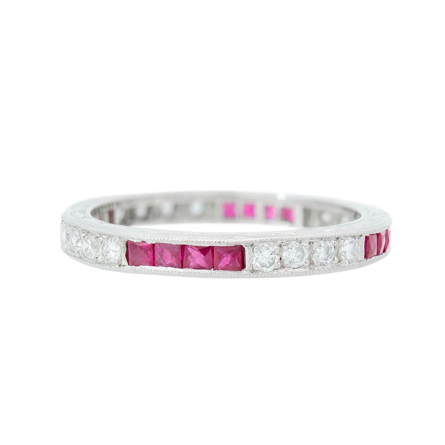 An absolutely gorgeous Estate diamond and ruby eternity band! Made of platinum, this feminine band is comprised of a pattern of four full cut diamonds and four french cut rubies, held within a channel setting. The alternating design carries around
