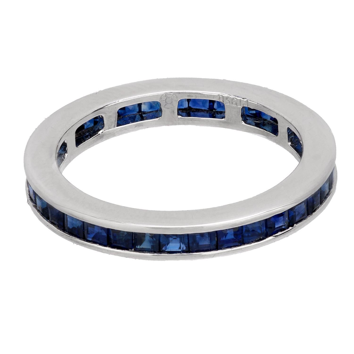 A beautiful sapphire eternity band! Crafted in platinum, this simple yet lovely band is comprised of a single row of deep blue square cut sapphires. The stones rest in a channel setting, which carries seamlessly around the entire outer entire