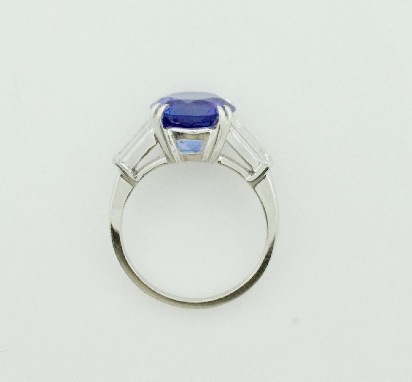 Introducing the stunning Estate Platinum Tanzanite and Diamond Ring, featuring a mesmerizing 3.51 carat round brilliant cut Tanzanite. This exquisite gemstone boasts extreme brilliance and is completely free of any visible imperfections to the naked