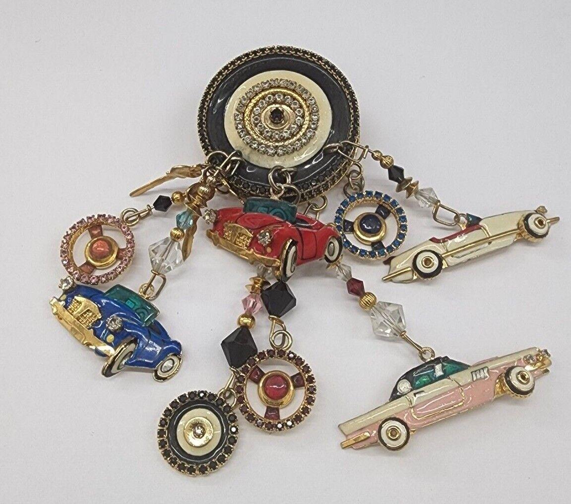 Awesome Large Enamel Multi Charm ON THE GO Dangle Car Themed Designer Brooch signed: LUNCH AT THE RITZ. This “Car Enthusiast” Brooch epitomizes Vintage charm with personality! Measuring approx. 4” long x 1.5” wide. Simply Fabulous! A Must Have