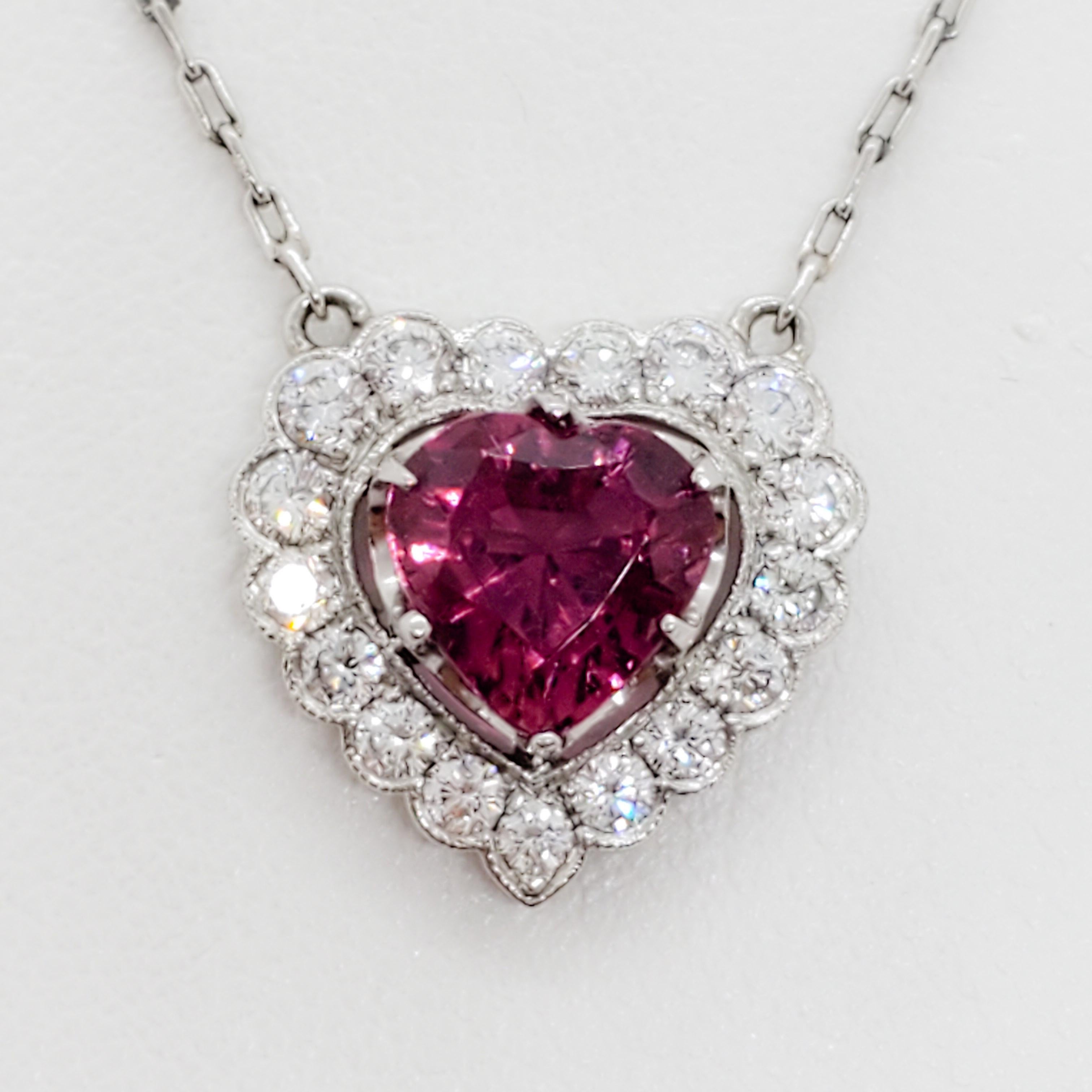 Gorgeous raspberry red tourmaline heart shape weighing 2.10 ct. with 1.25 ct. good quality white diamond rounds.  Handmade platinum mounting and chain.  
