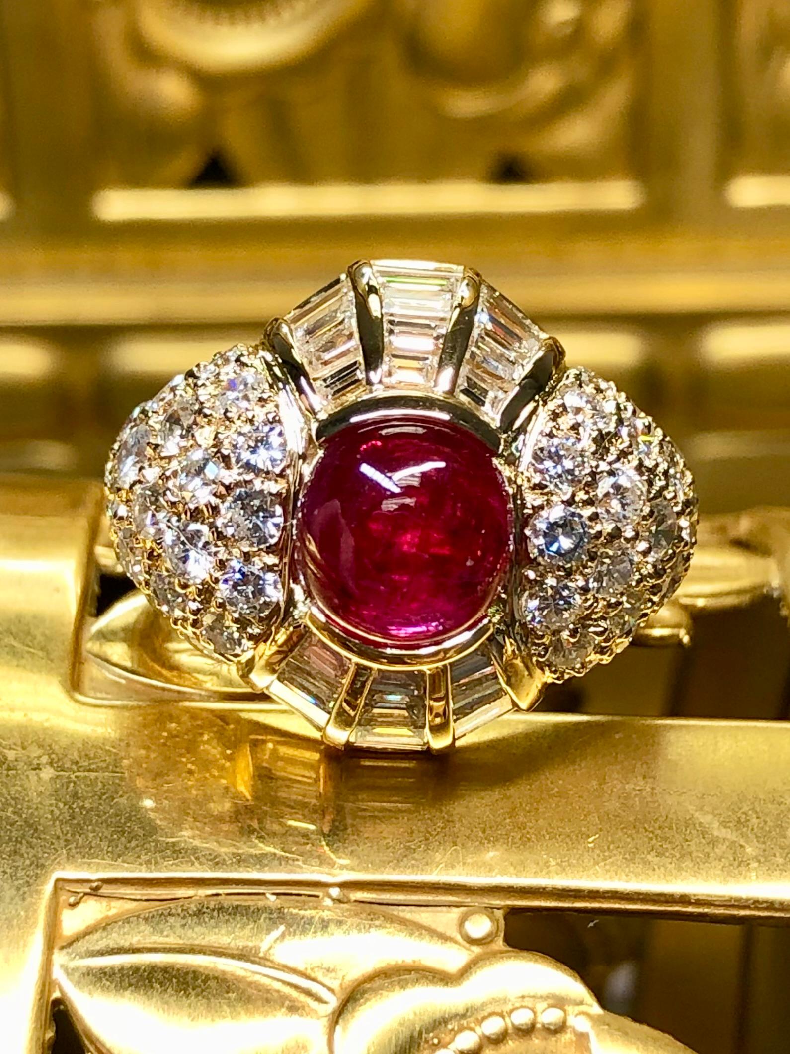 
An absolutely exquisite ring crafted in 18K yellow gold and centered by an approximately 3ct vivid red ruby cabochon. We can only describe the color but the video and pictures tell the full story. This ring has also been both channel and flush set