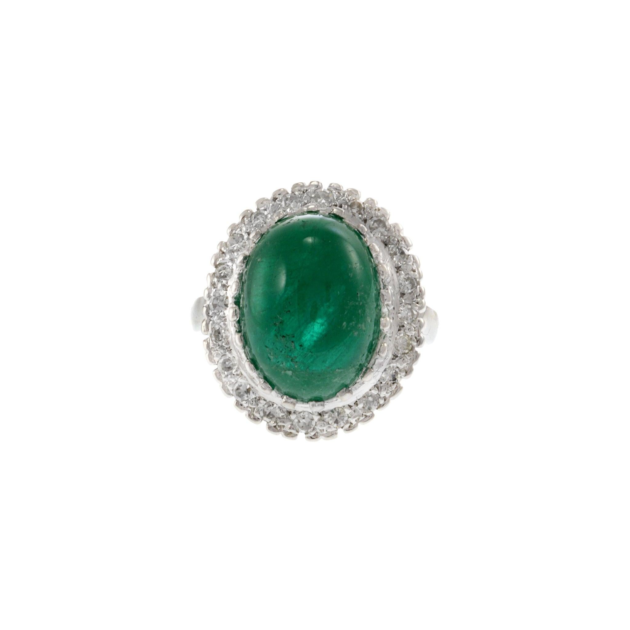 Estate Retro Era 14KT White Gold Genuine 8.19CT Cabochon Emerald and Diamond Ring. This stunning piece features a genuine 8.19 carat cabochon emerald, complemented by 0.70 carats of G-VS single cut round diamonds. Crafted from luxurious 14KT white